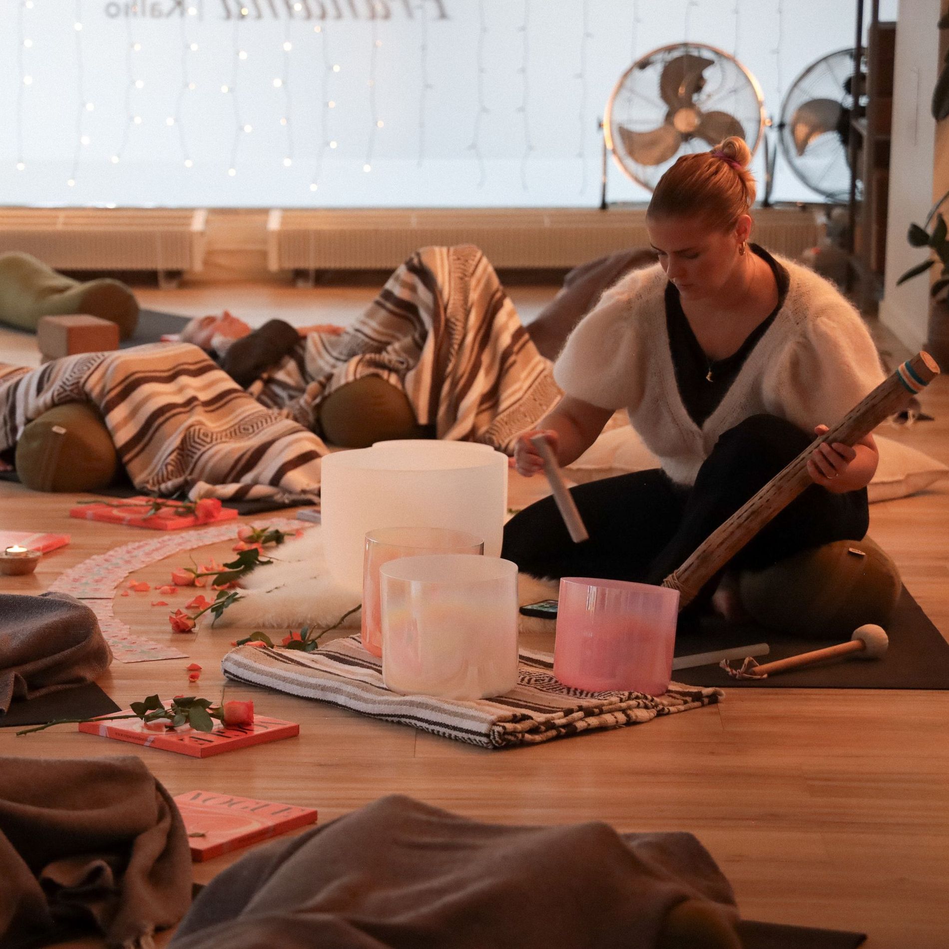 Woman practicing sound healing yoga in her studio