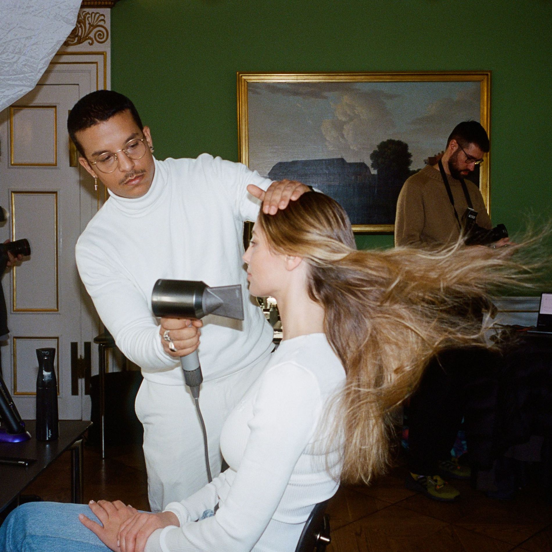 A model gets her hair blowdried backstage at the Garment's AW24 Copenhagen Fashion Week Show