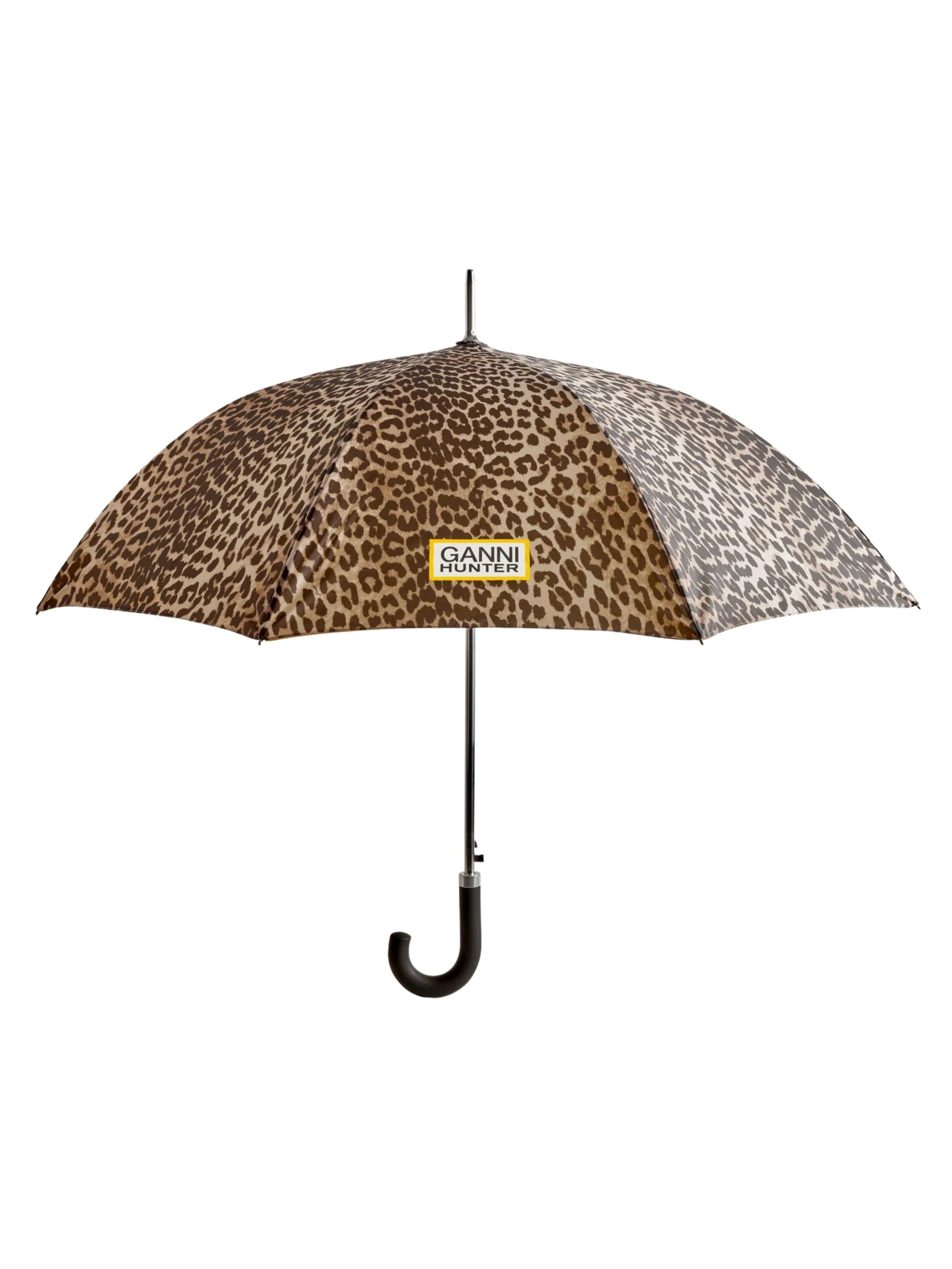 Leopard print umbrella against a white background