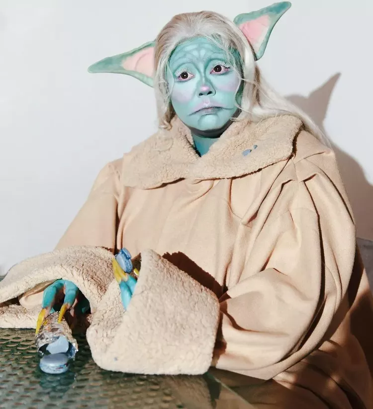 Lizzo dressed as Baby Yoda. 