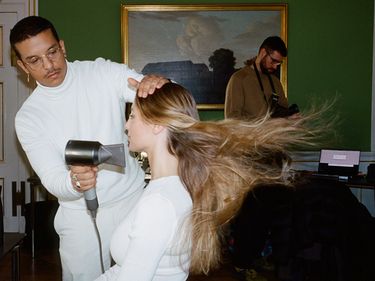 A model gets her hair blowdried backstage at the Garment's AW24 Copenhagen Fashion Week Show