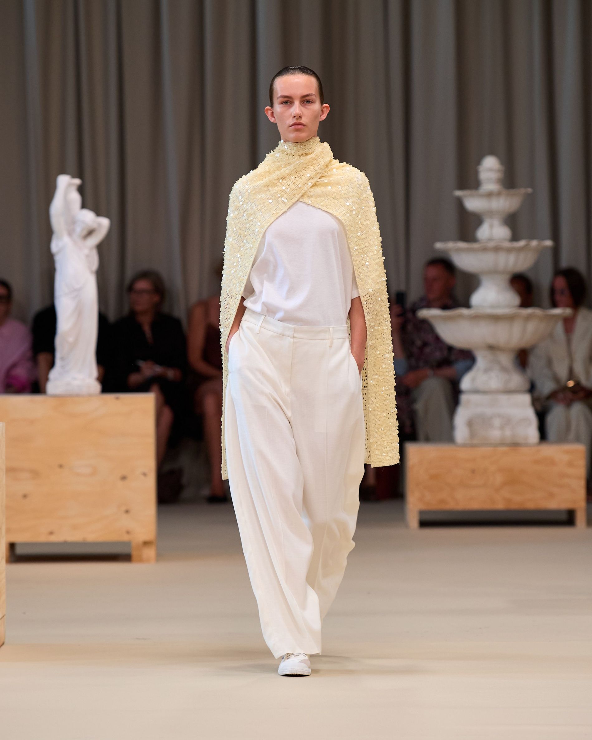Butter yellow sequin cape paired with a white t-skirt and white costume pants
