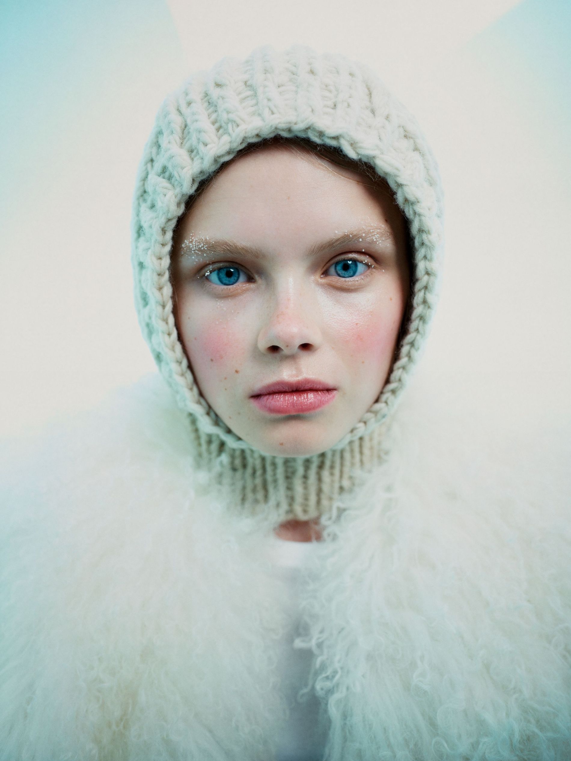 Model poses with red cheeks, snow-brushed brows and a balaclava