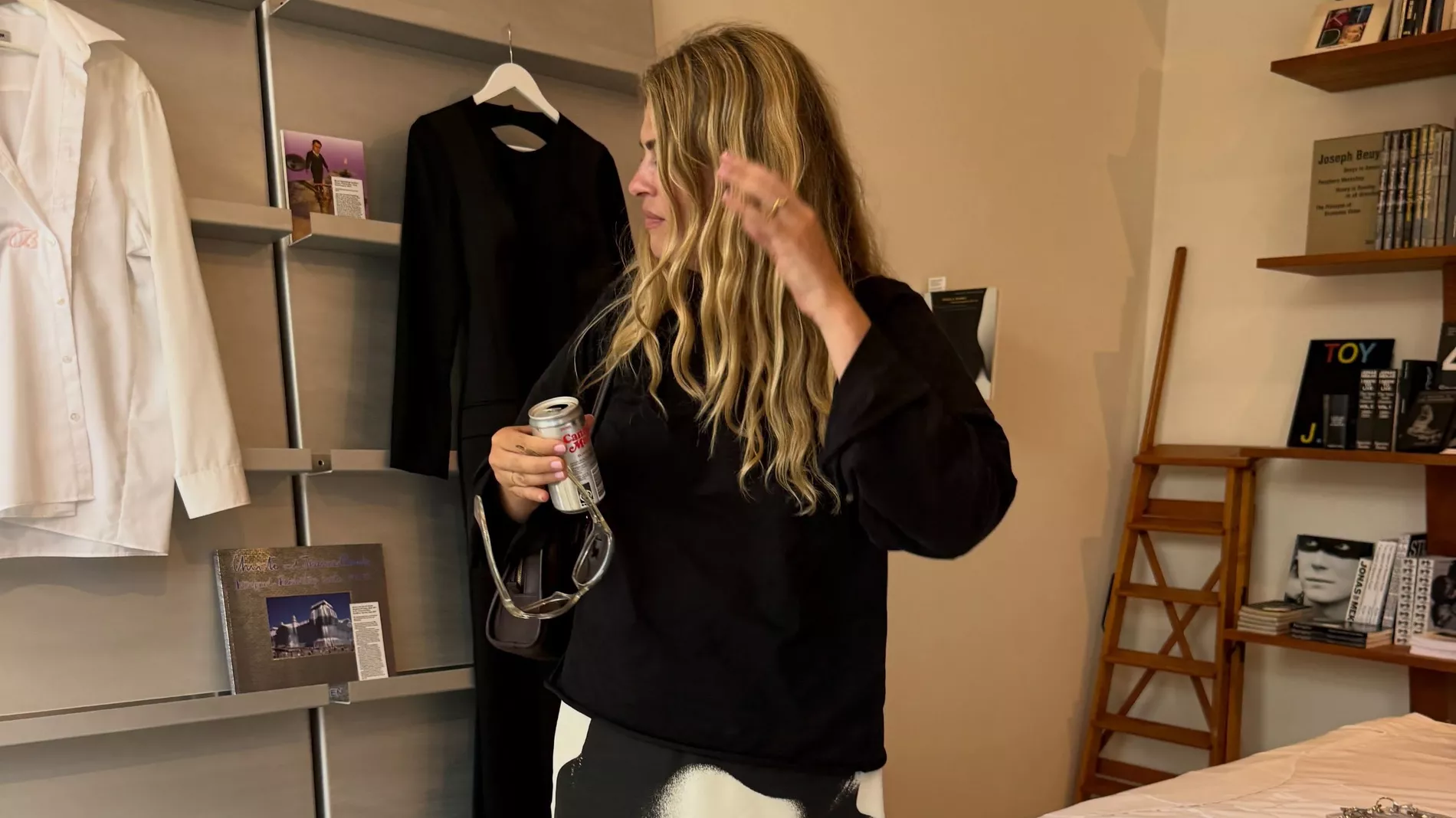 Sidsel Alling stands in a room wearing black jumper, black sandals and a Versace skirt