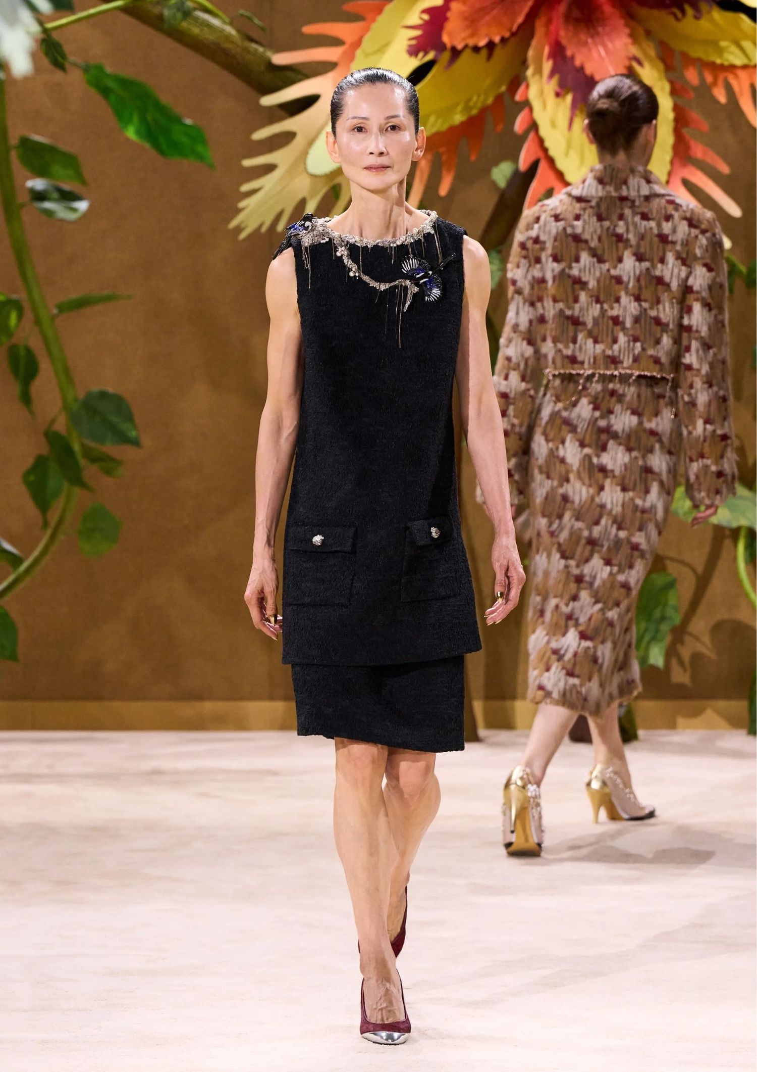 Black mini dress paired with a black skirt and silver neckless