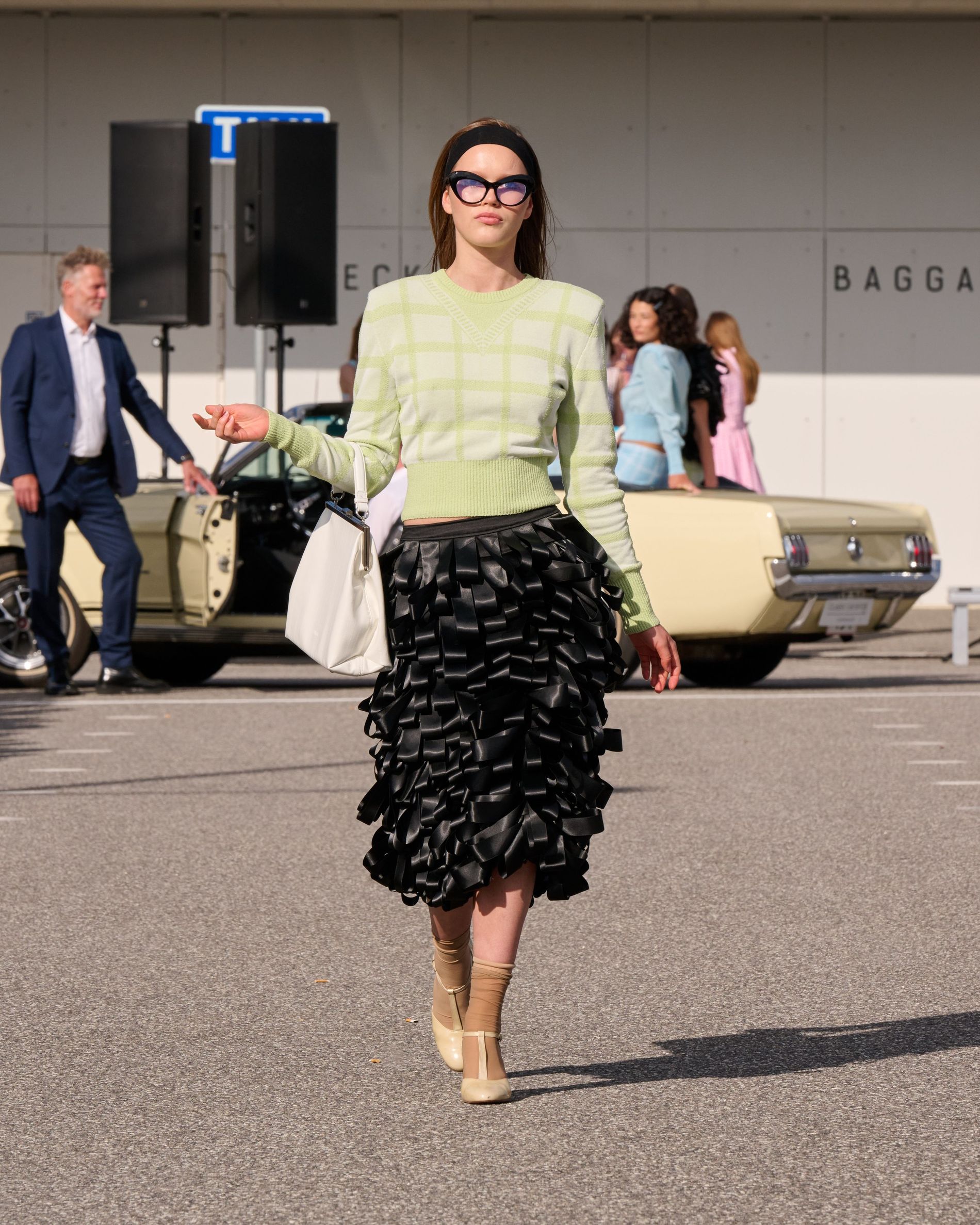 Mid texture skirt paired with a gren checked knit sweater
