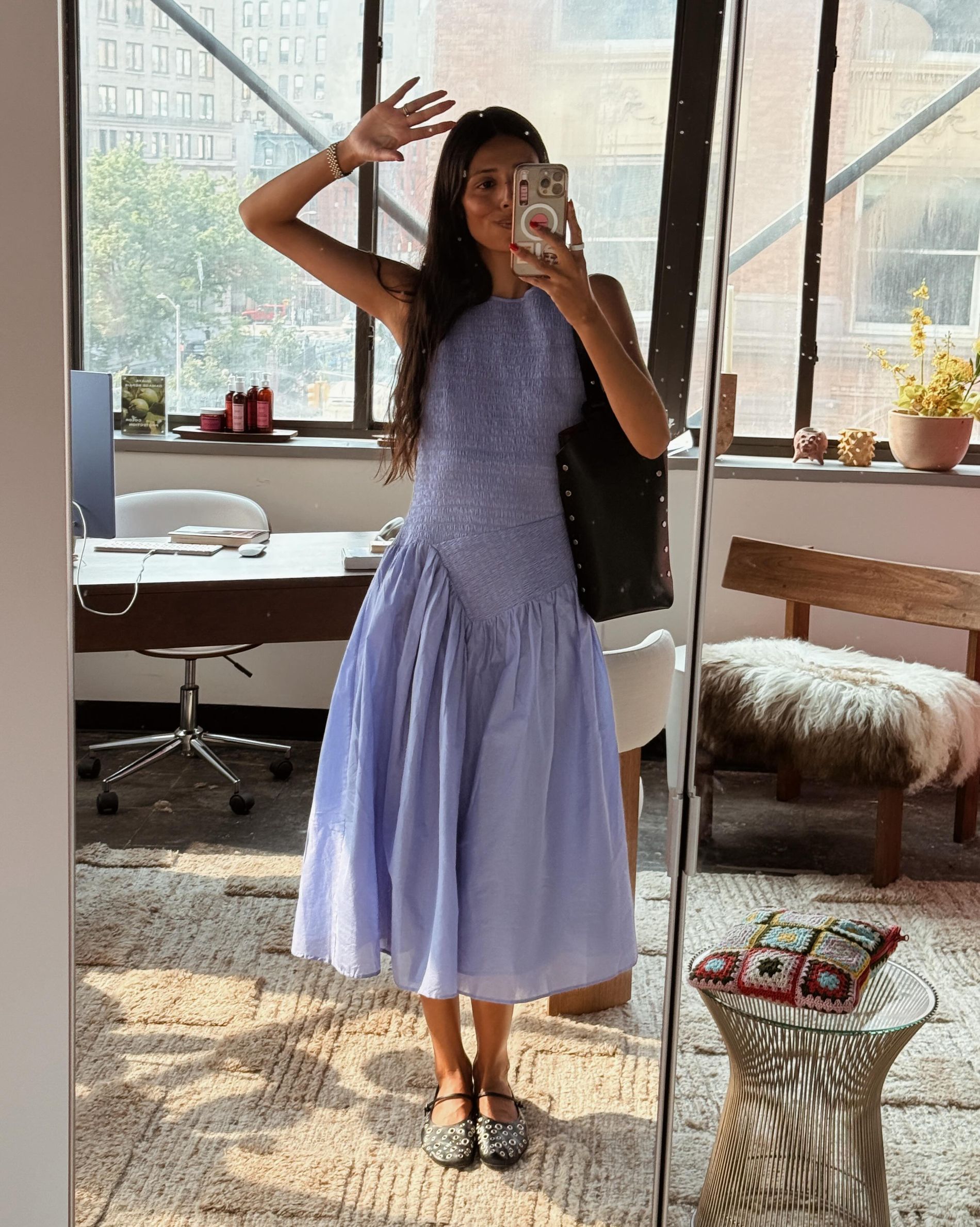 Babba wears a lilac midi dress and eyelet ballet flats