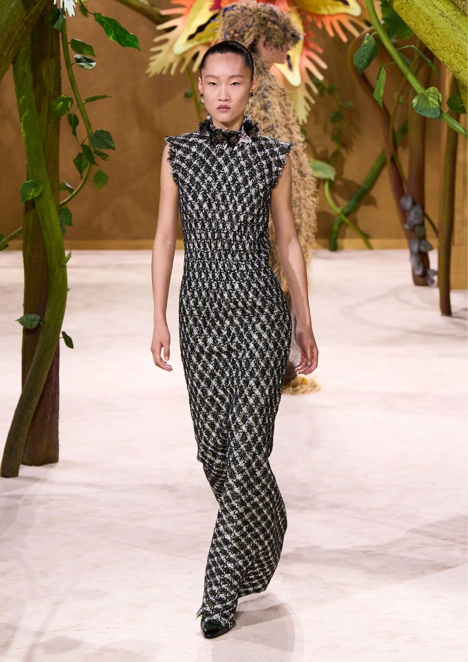 Sleeveless fitted tweed dress with a high neckline and pointed-toe pumps