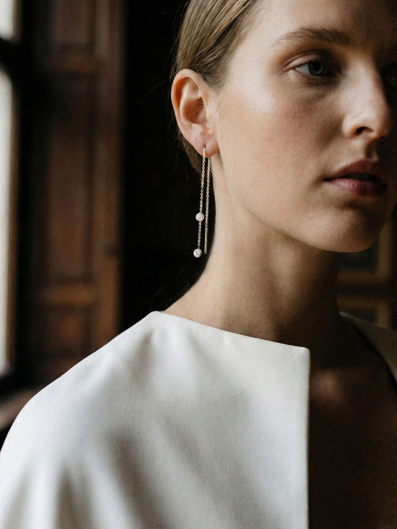 A model wears Ton Ton's diamond threader earring in white gold