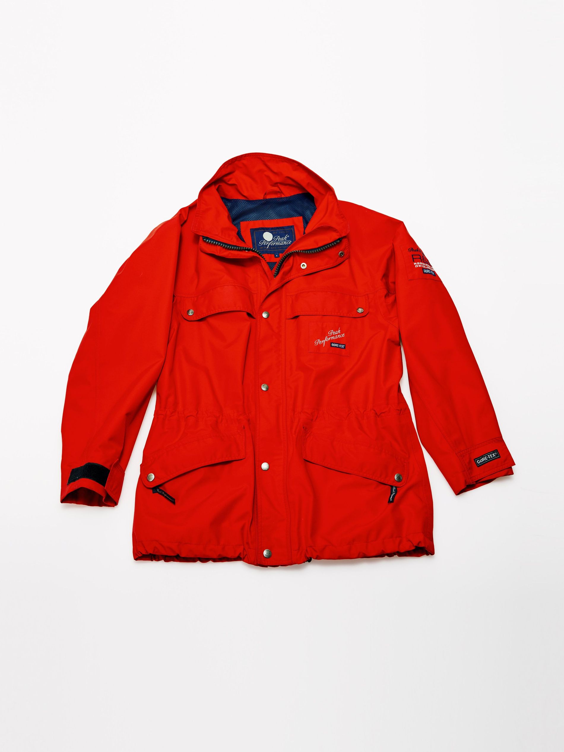 The original R&D Long Jacket from Peak Performance in bright red, photographed on a white background