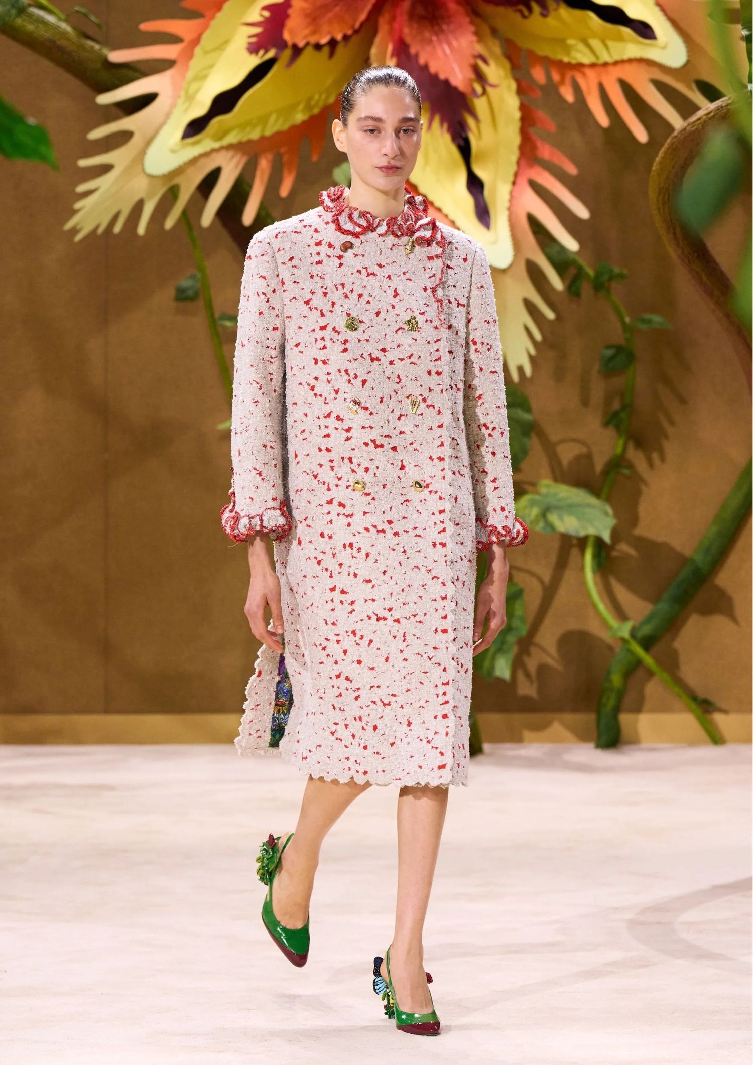 Long white cape with red spots on