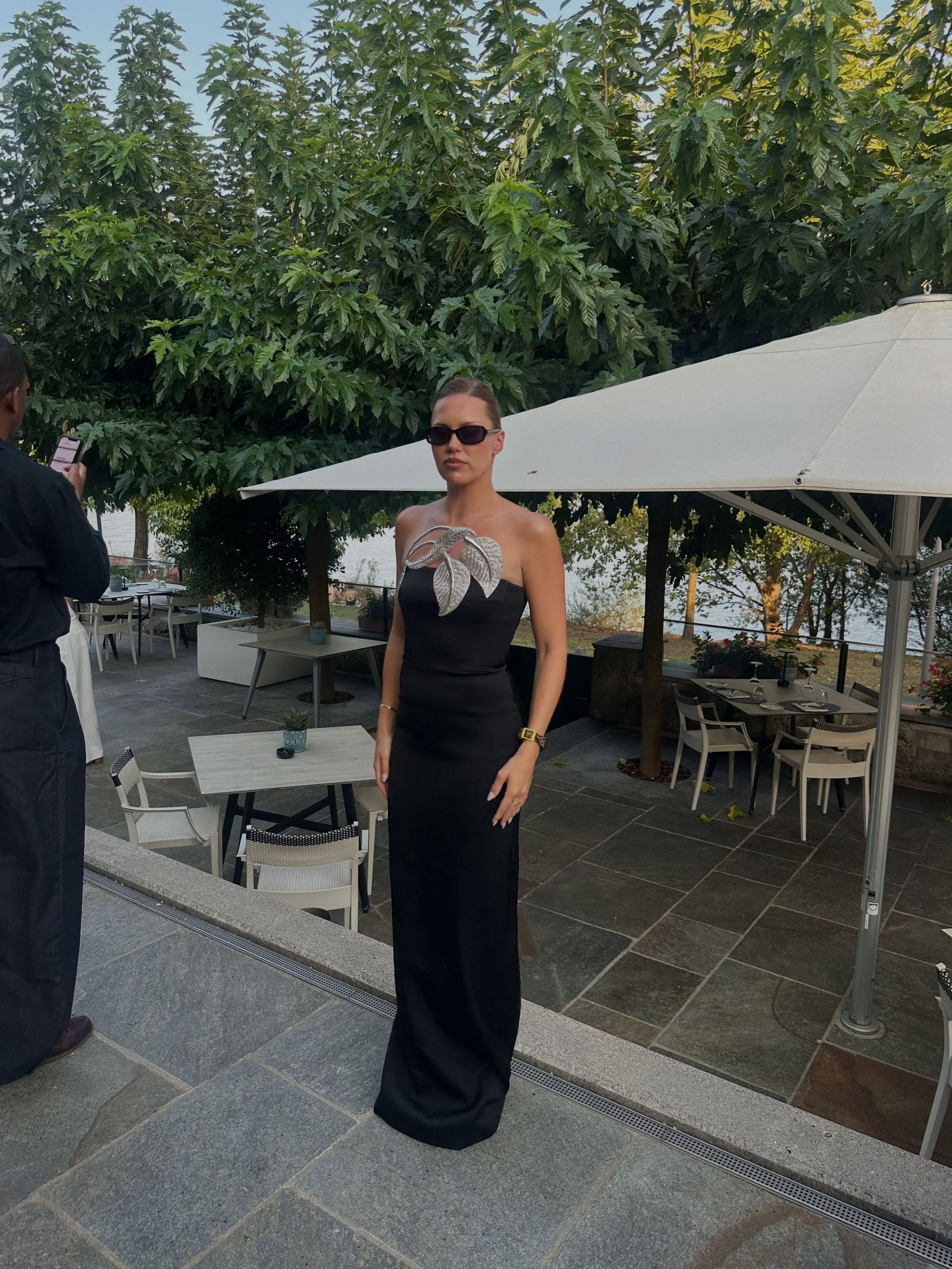 Caroline wears a black and silver maxi dress and swatch watch