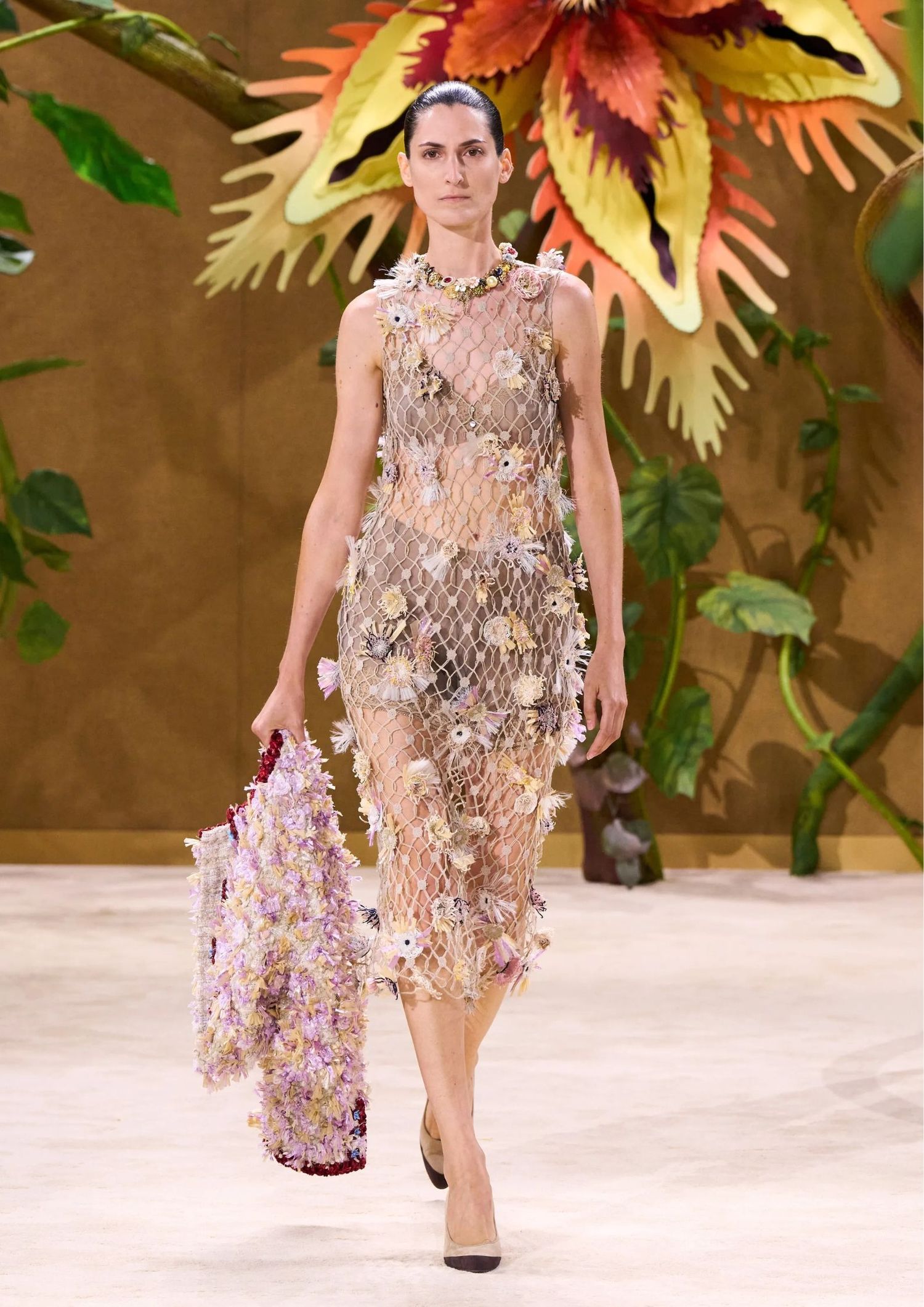 Sheer sleeveless floral appliqué dress, with pointed-toe pumps.