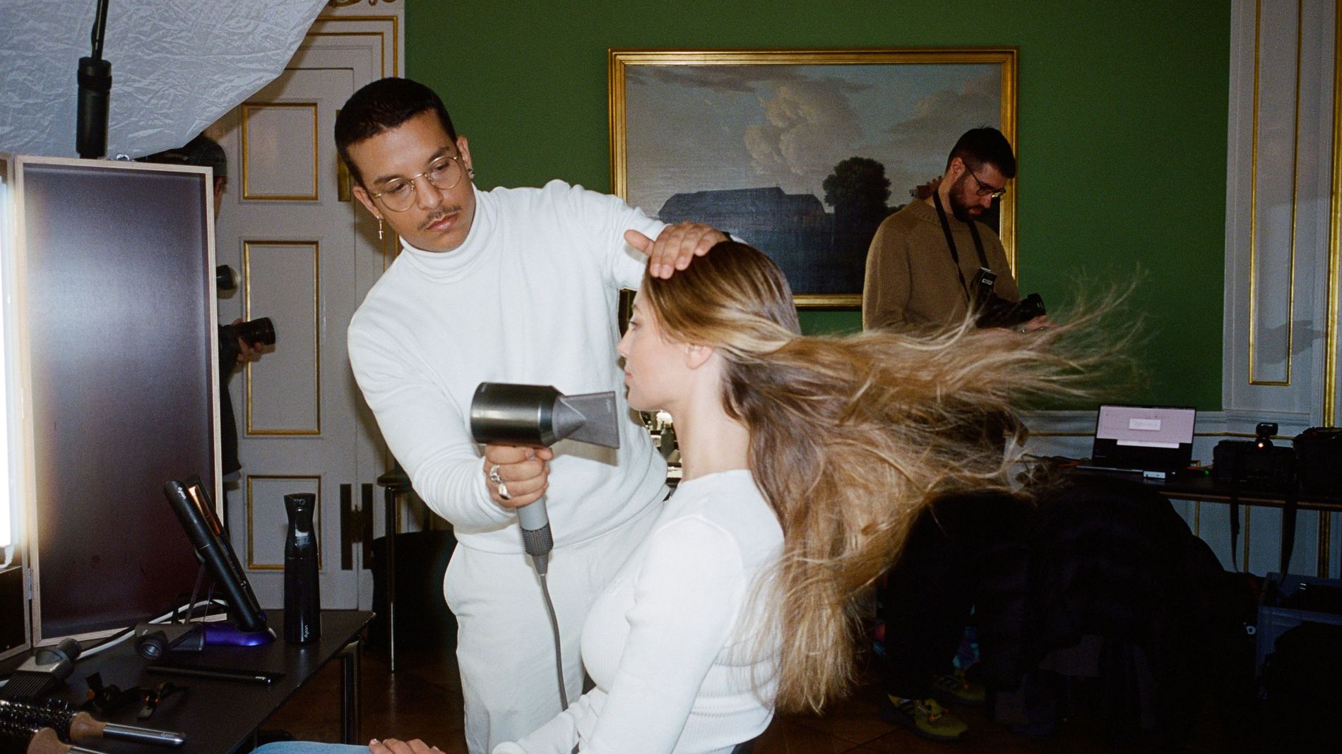 A model gets her hair blowdried backstage at the Garment's AW24 Copenhagen Fashion Week Show