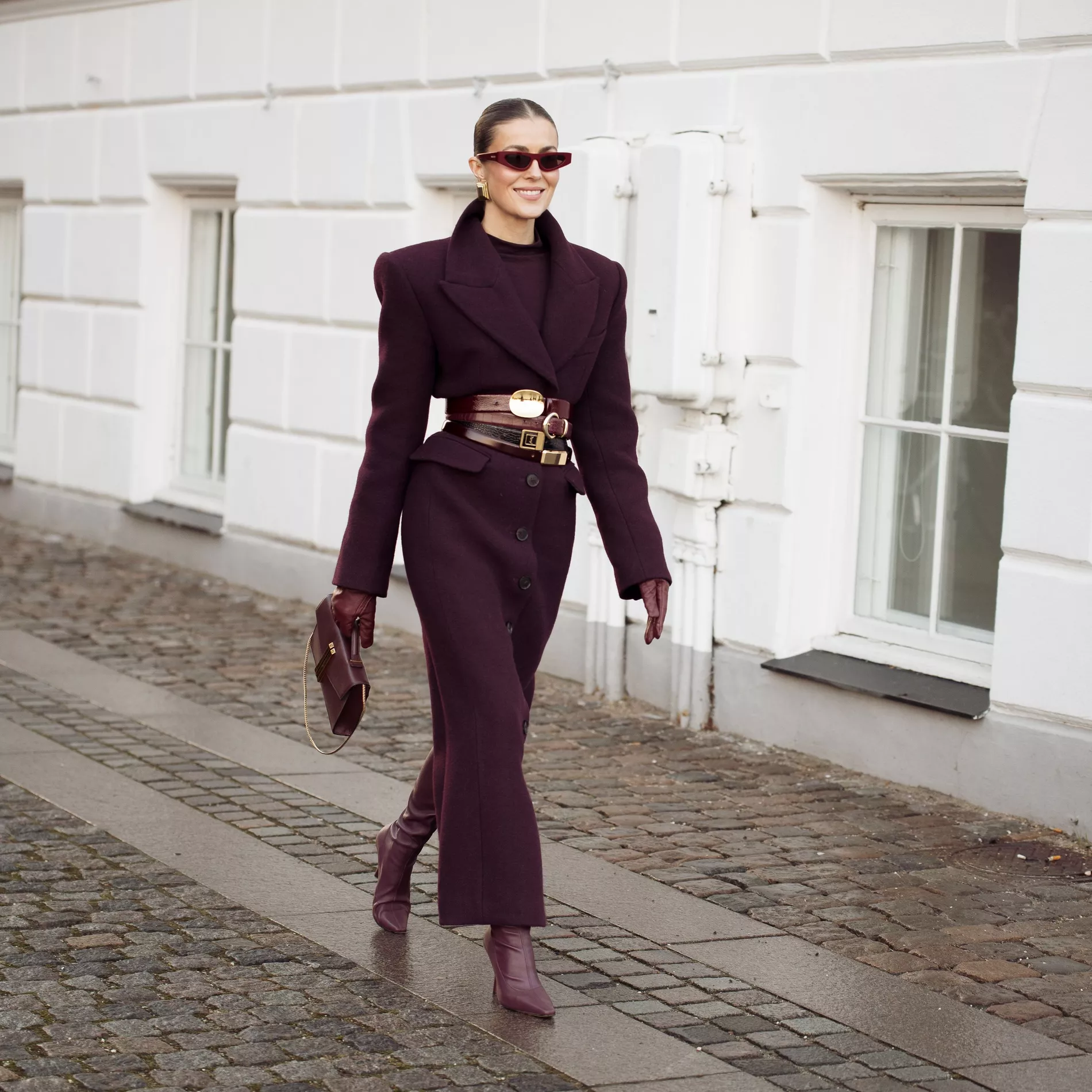Nina Sandbech wearing a full monochrome look in burgundy with stacked belts 