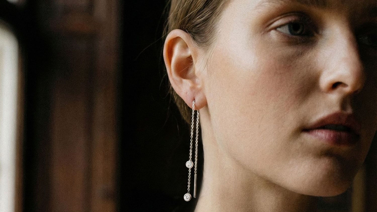 A model wears Ton Ton's diamond threader earring in white gold