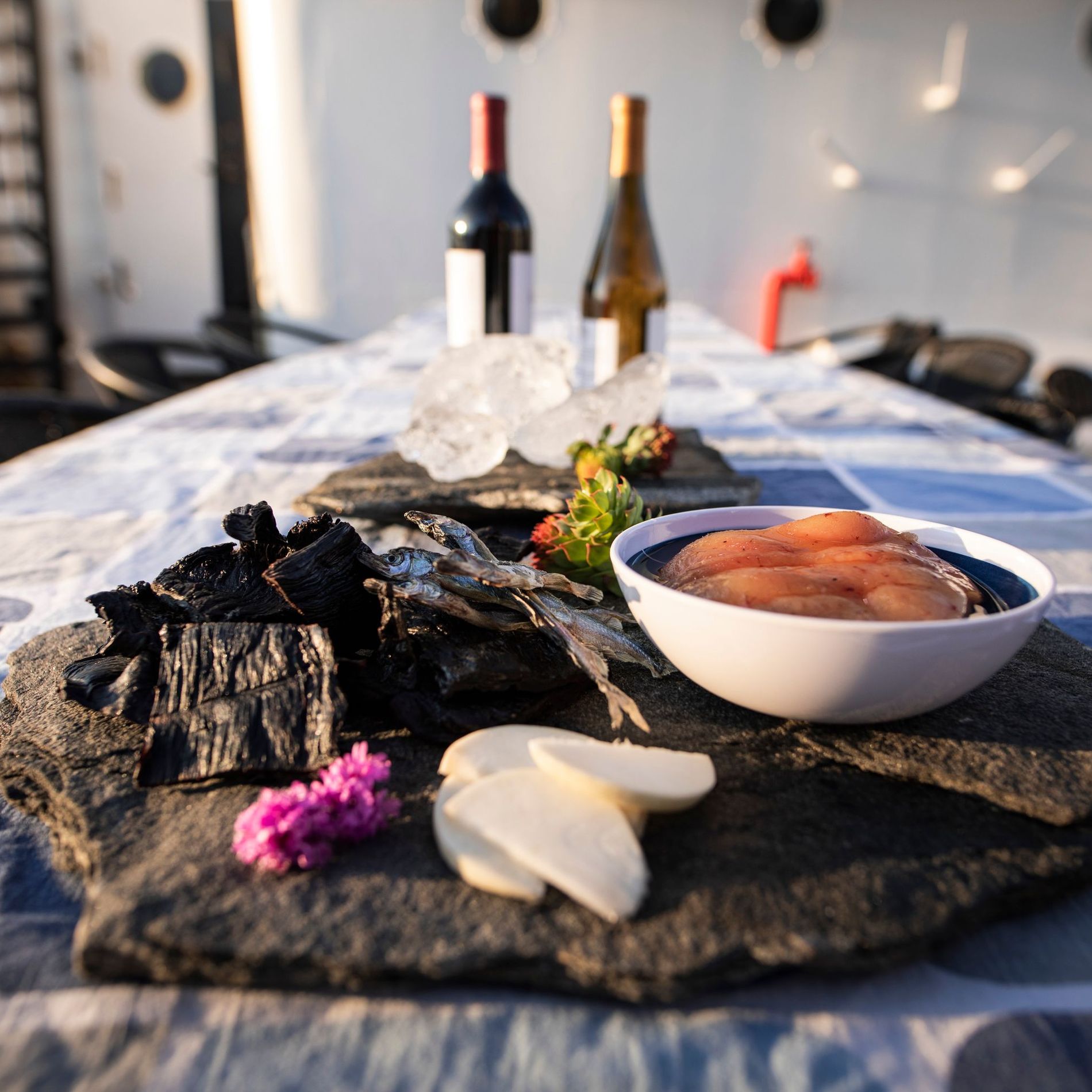 South Greenlandic soul food with fish and wine arranged on a table in the sunshine