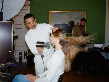 A model gets her hair blowdried backstage at the Garment's AW24 Copenhagen Fashion Week Show
