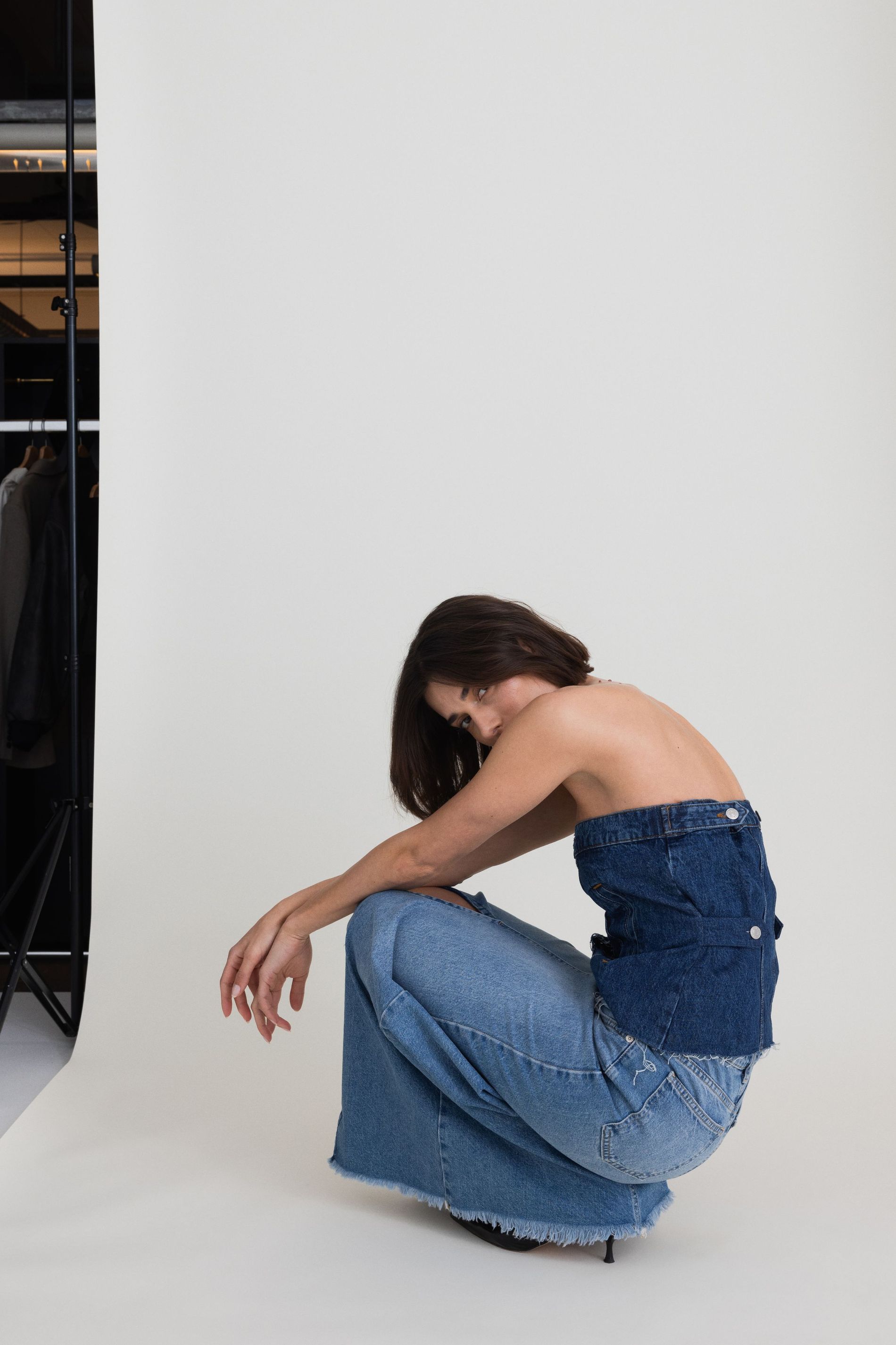 Model poses with remade denim pieces