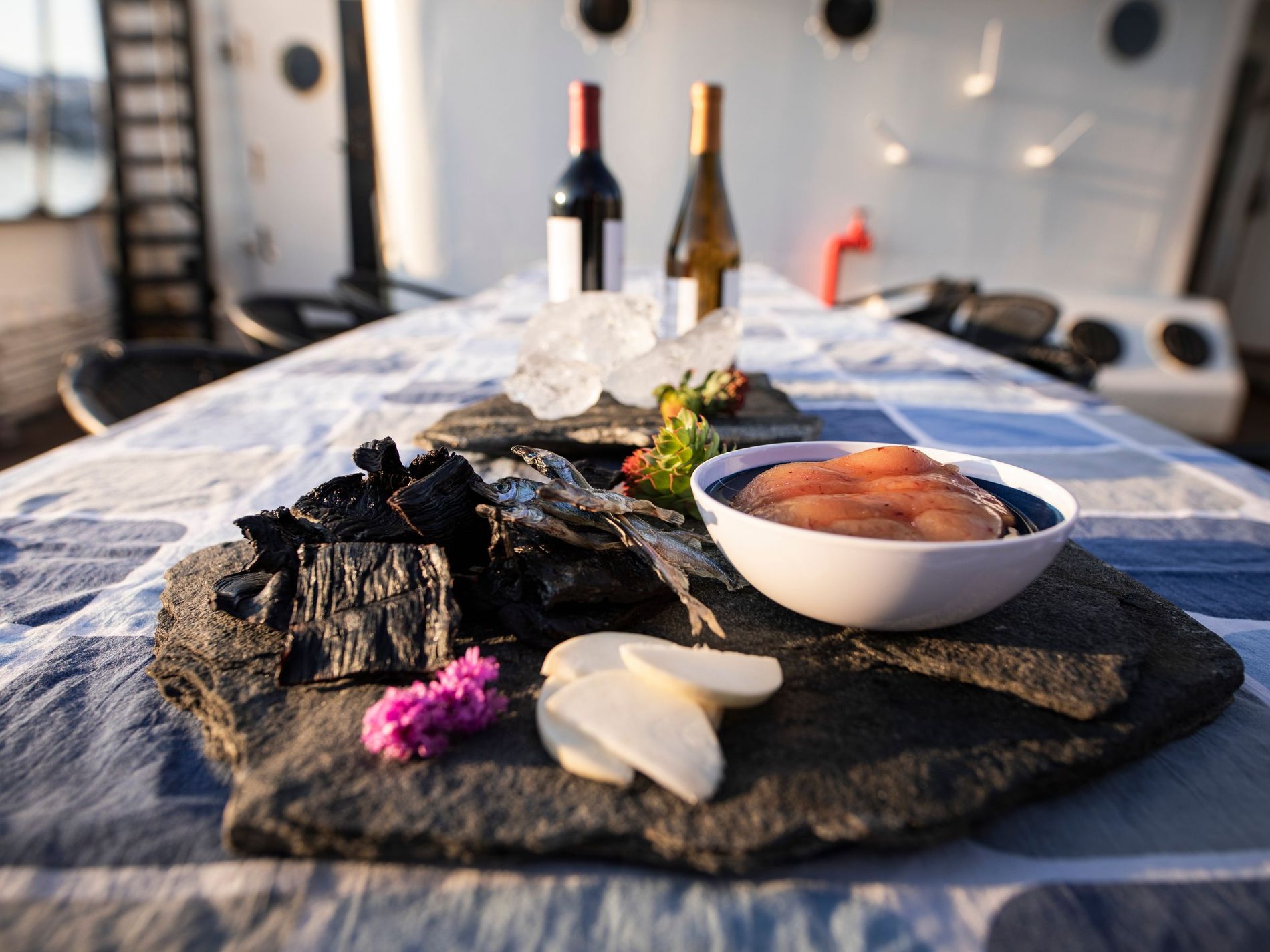 South Greenlandic soul food with fish and wine arranged on a table in the sunshine