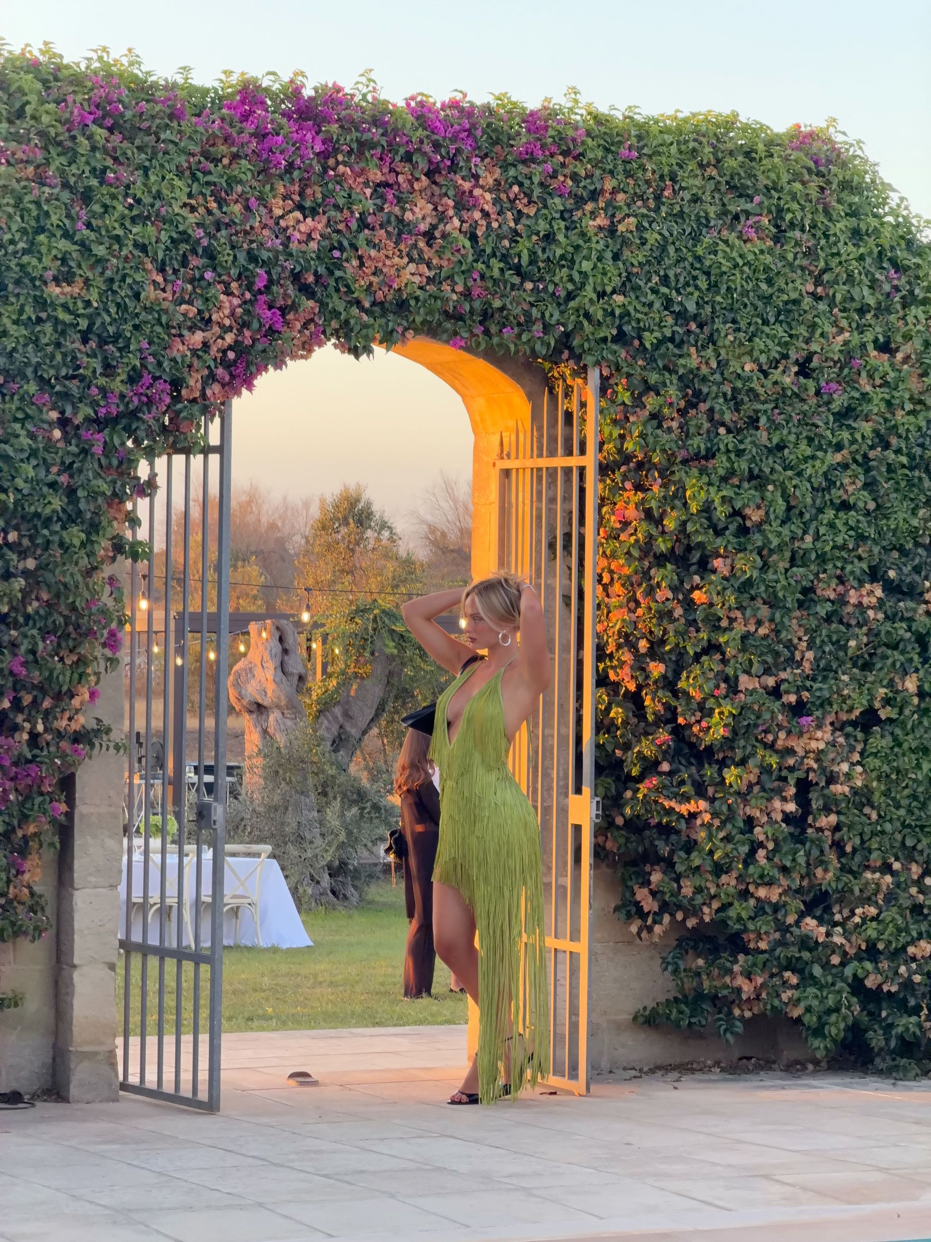 Alice wears green fringed maxi dress
