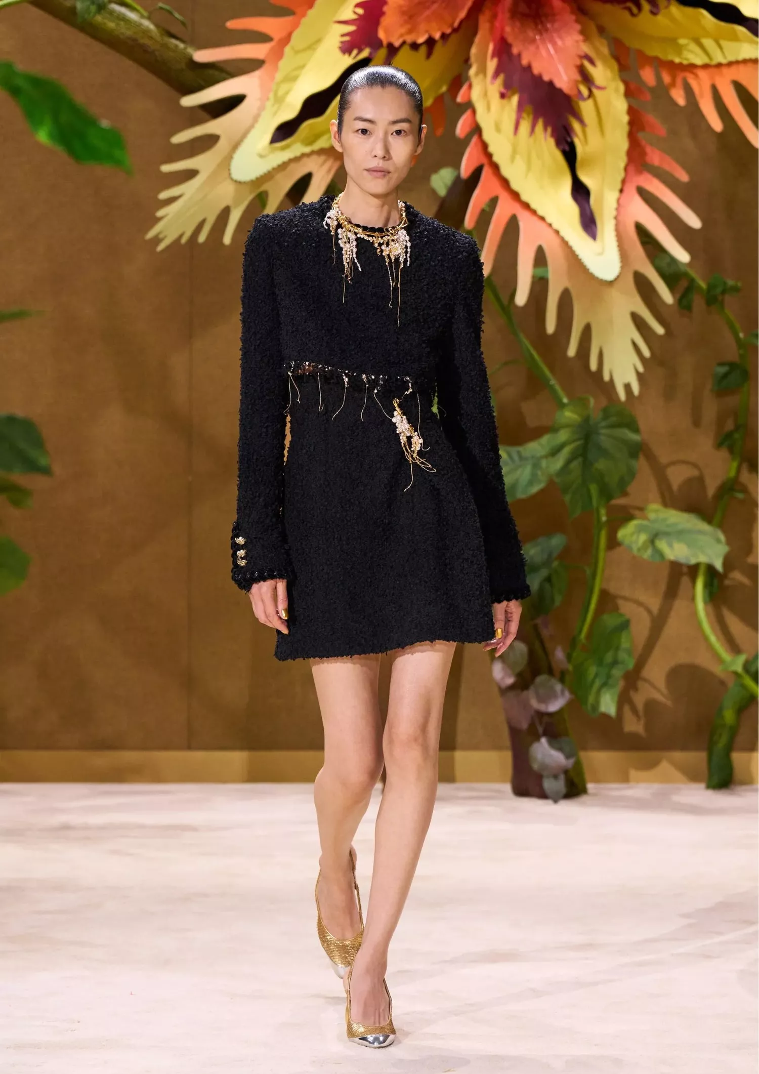 Black textured mini dress with gold neckless