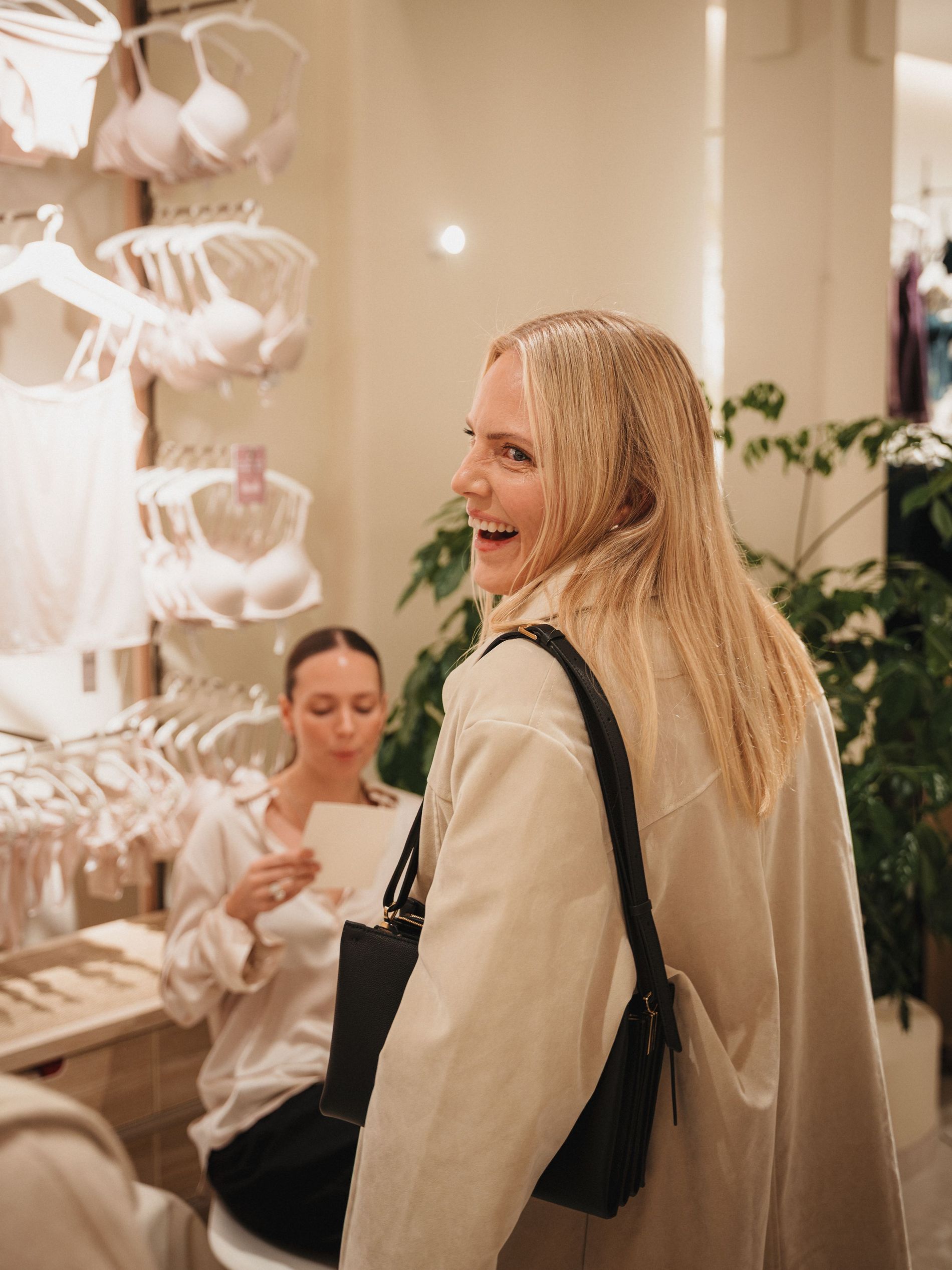 Blonde girl in a trenchcoat on the intimissimi X Vogue Scandinavia event