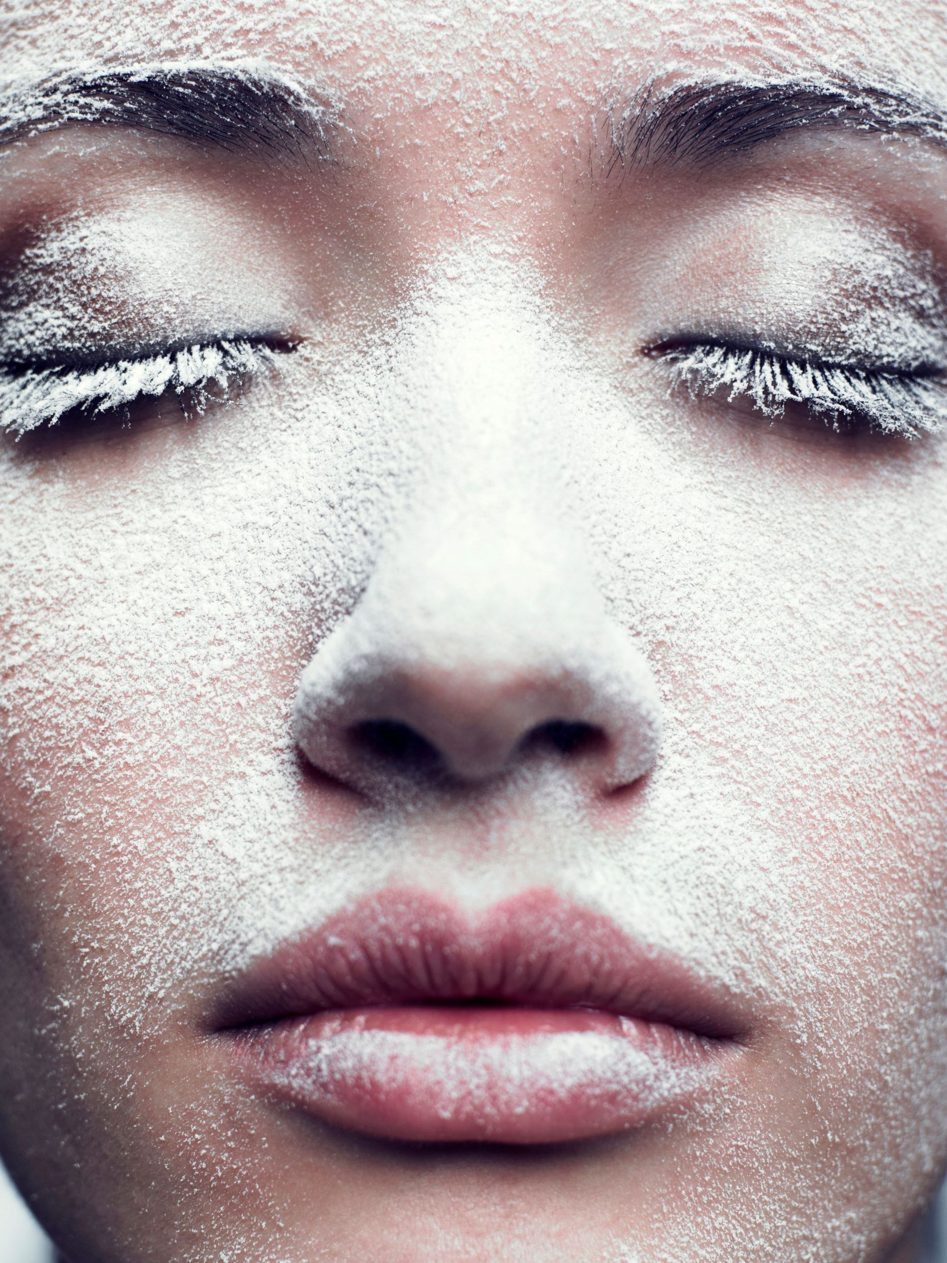 A model poses with and excess of setting powder dusted over her face