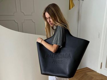 Pernille Teisbaek carries an XXL Balenciaga bag on her shoulder