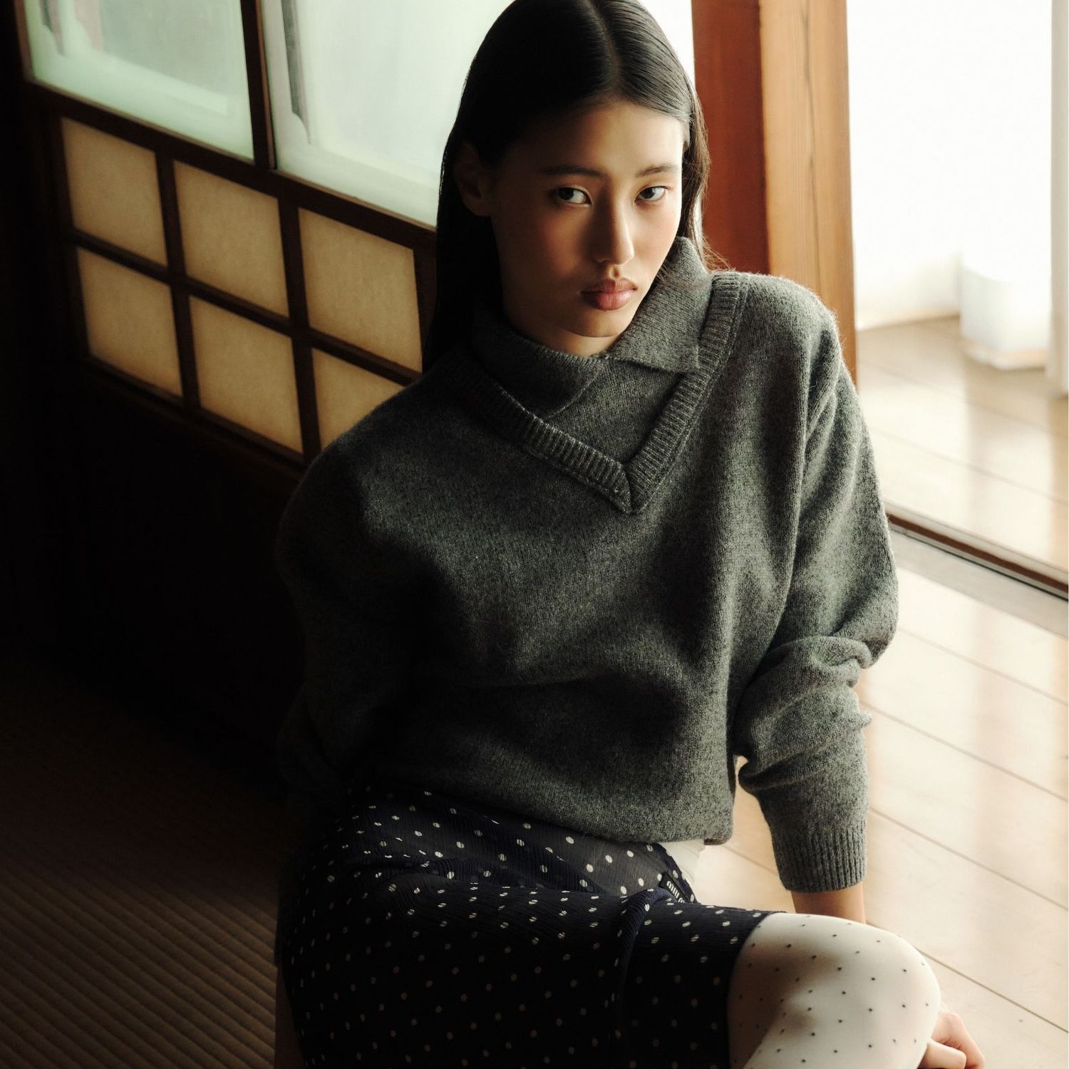 A stunning model sitting on the floor in Japan 