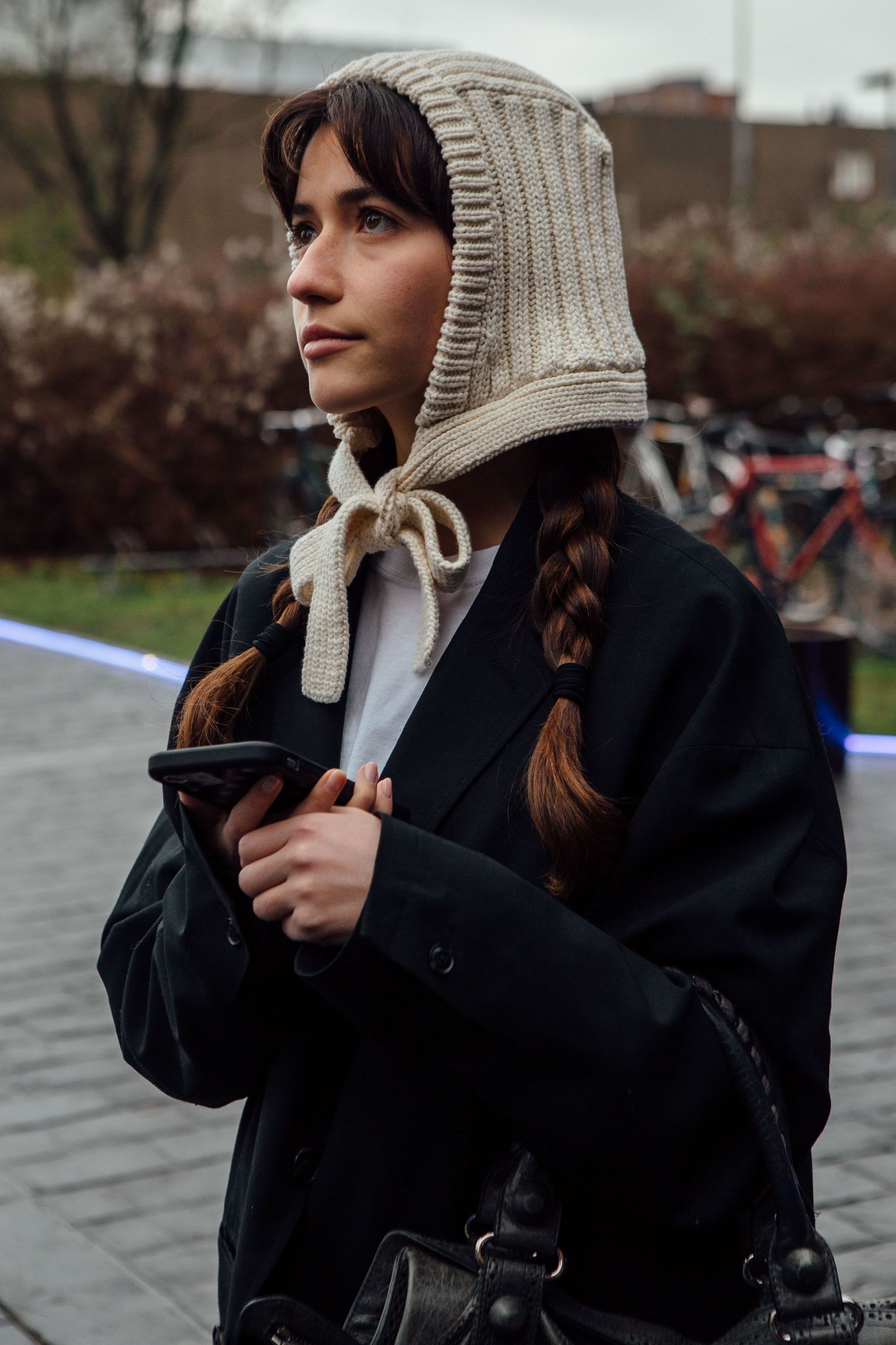 Guest with braids wear a beige tie-front balaclava and black blazer