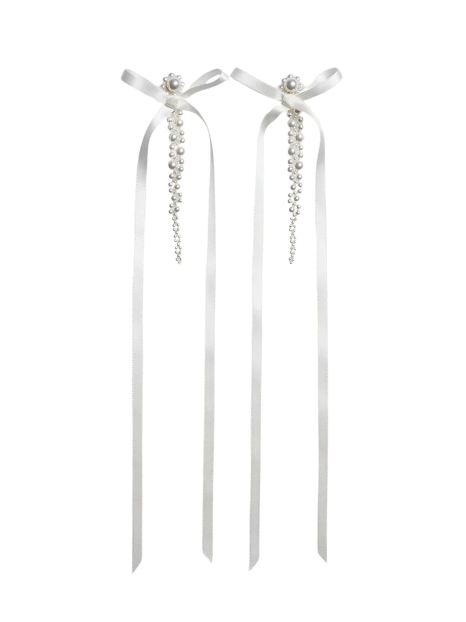Bow and pearl earrings from Simone Rocha against a white backround