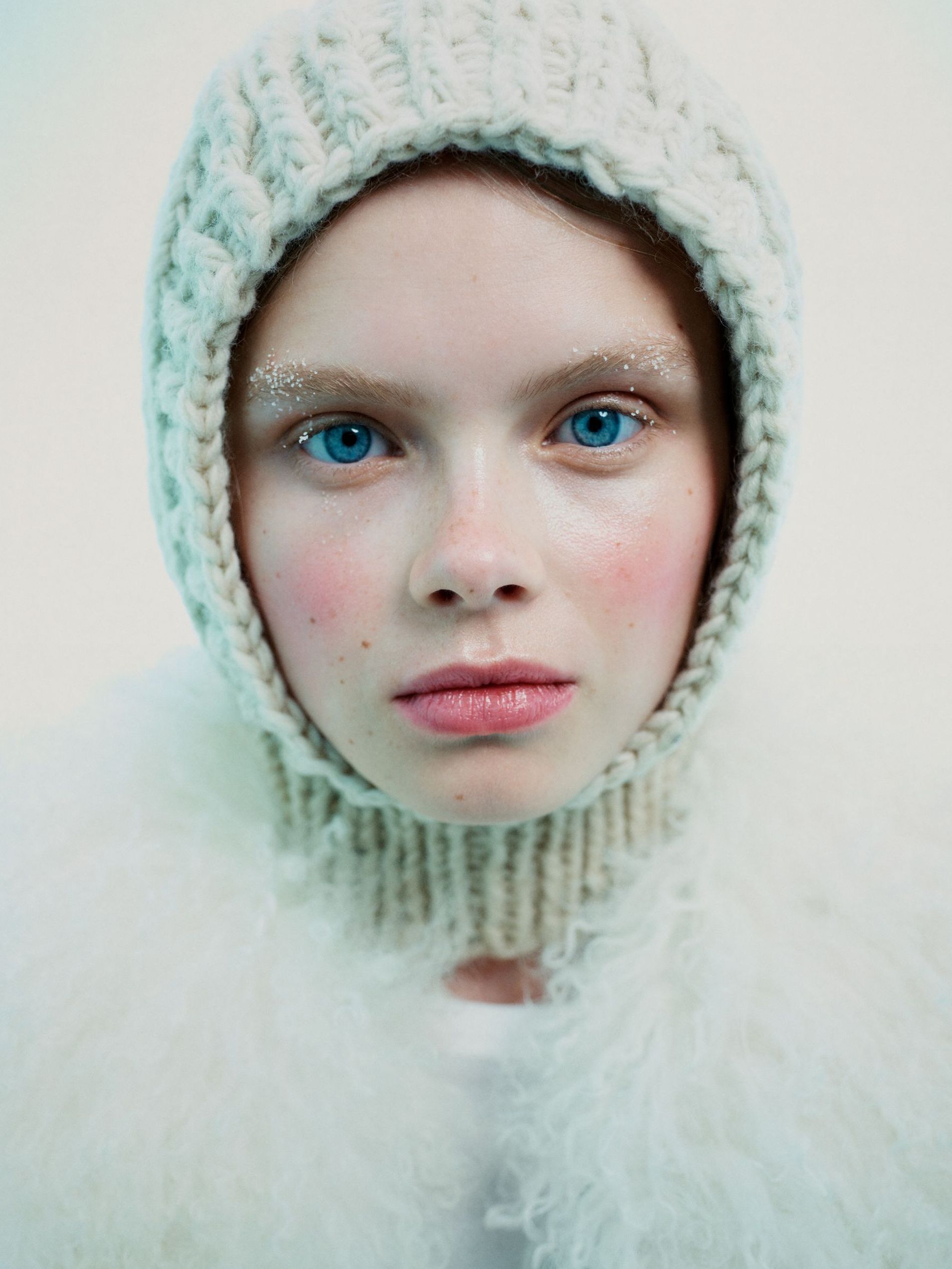 Model poses with red cheeks, snow-brushed brows and a balaclava