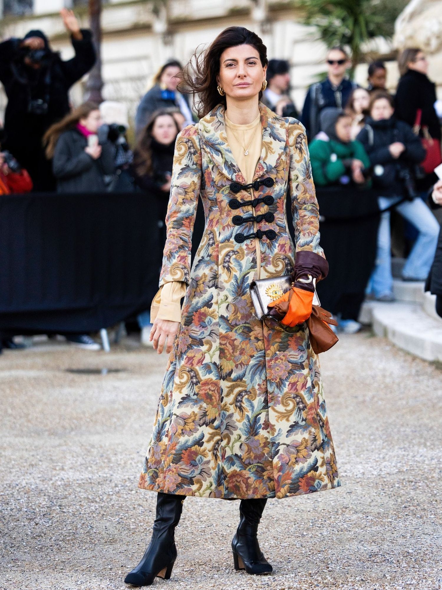 Giovanna Engelbert on the streets of Paris wearing patterned coat, black leather boots and Schiaparelli bag 