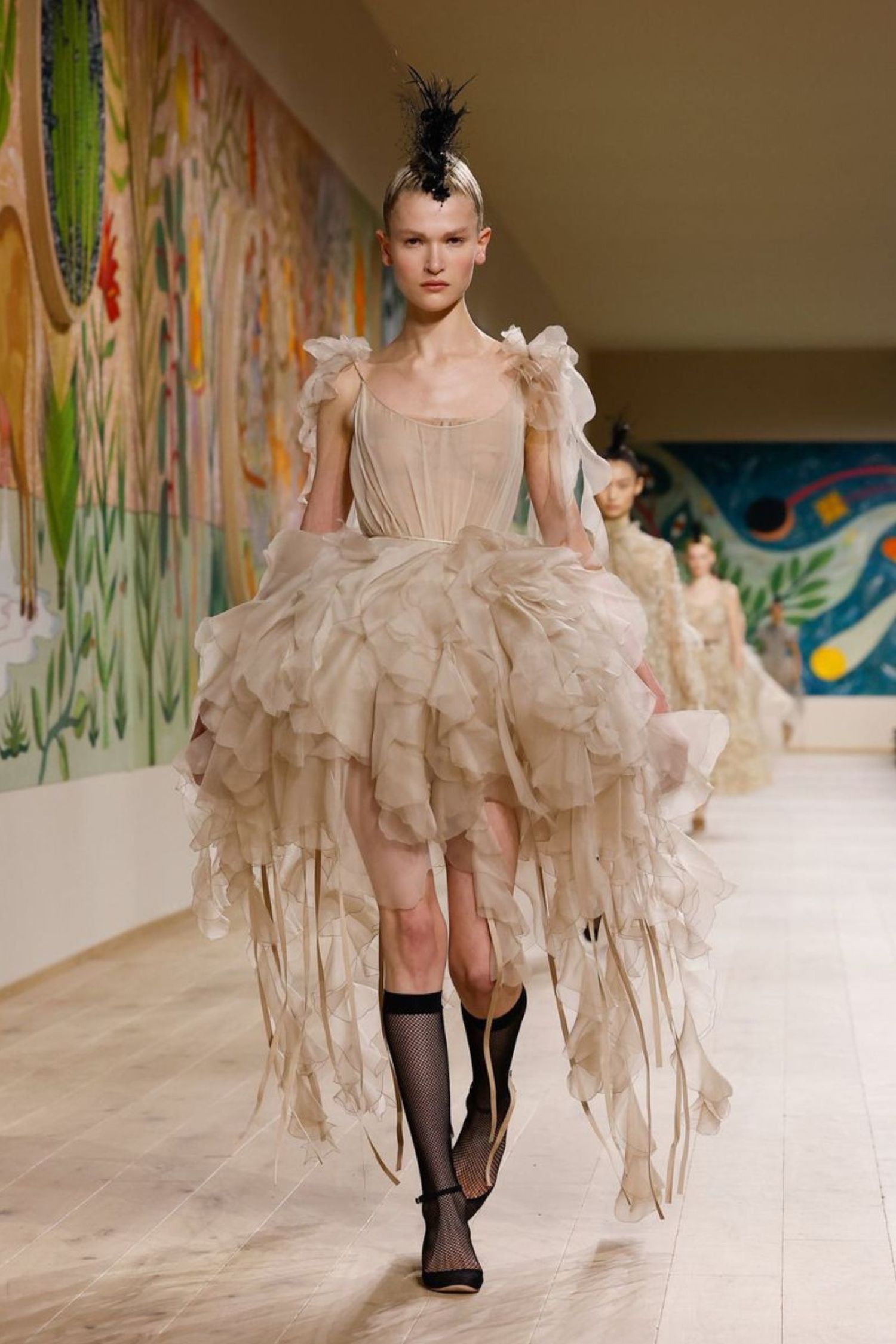 Sascha Rajasalu walking the Dior haute couture show in Paris wearing a tulle skirt and corset top in beige 