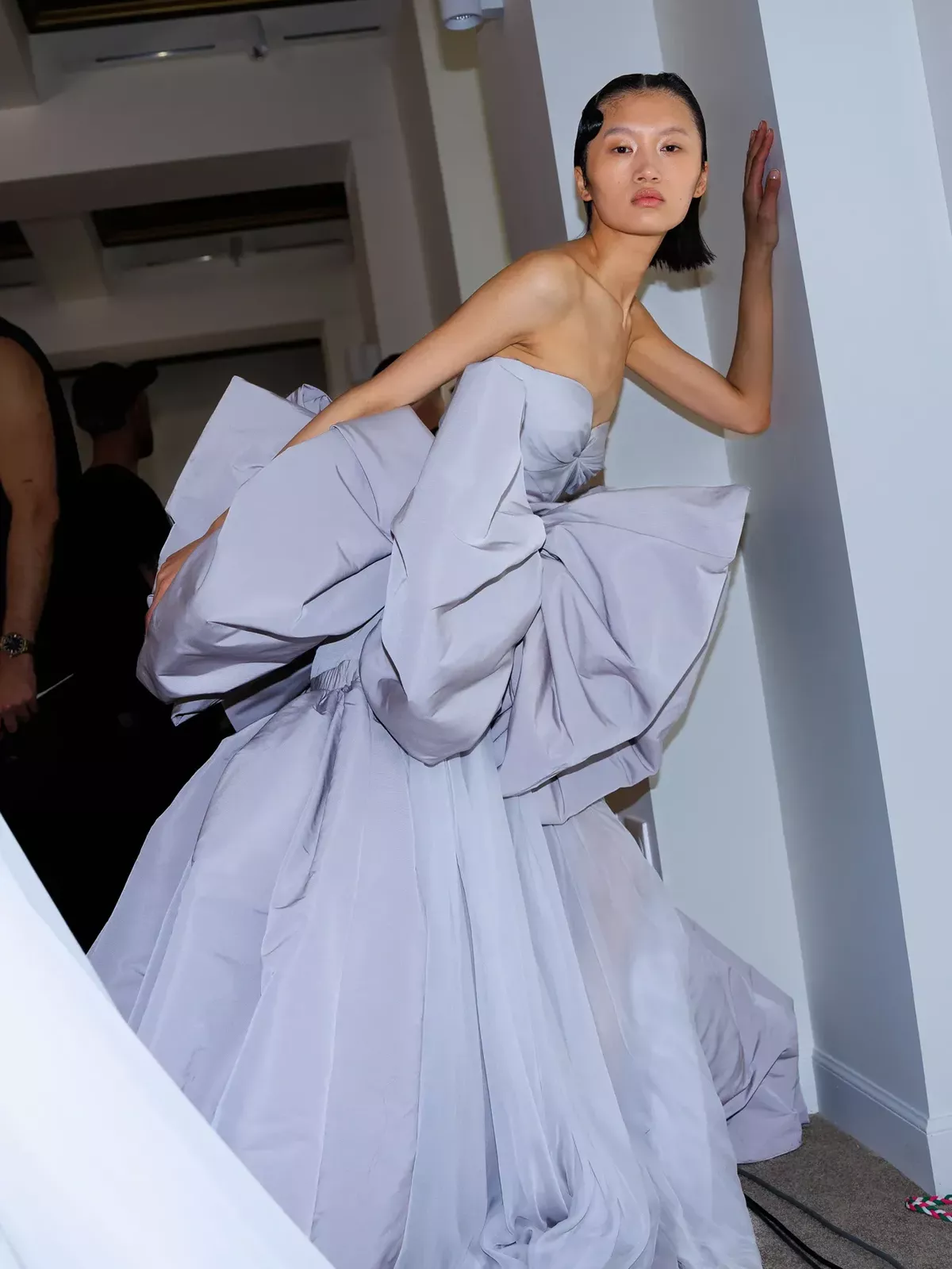 A lilac strapless haute couture gown with a sculptural bow waist behind the scenes at Giambattista Valli haute couture AW23