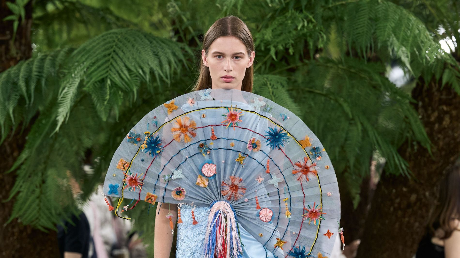 Model wearing a big fan-adorned pale blue dress on Dior's Haute Couture Fawll/winter 2026 runway