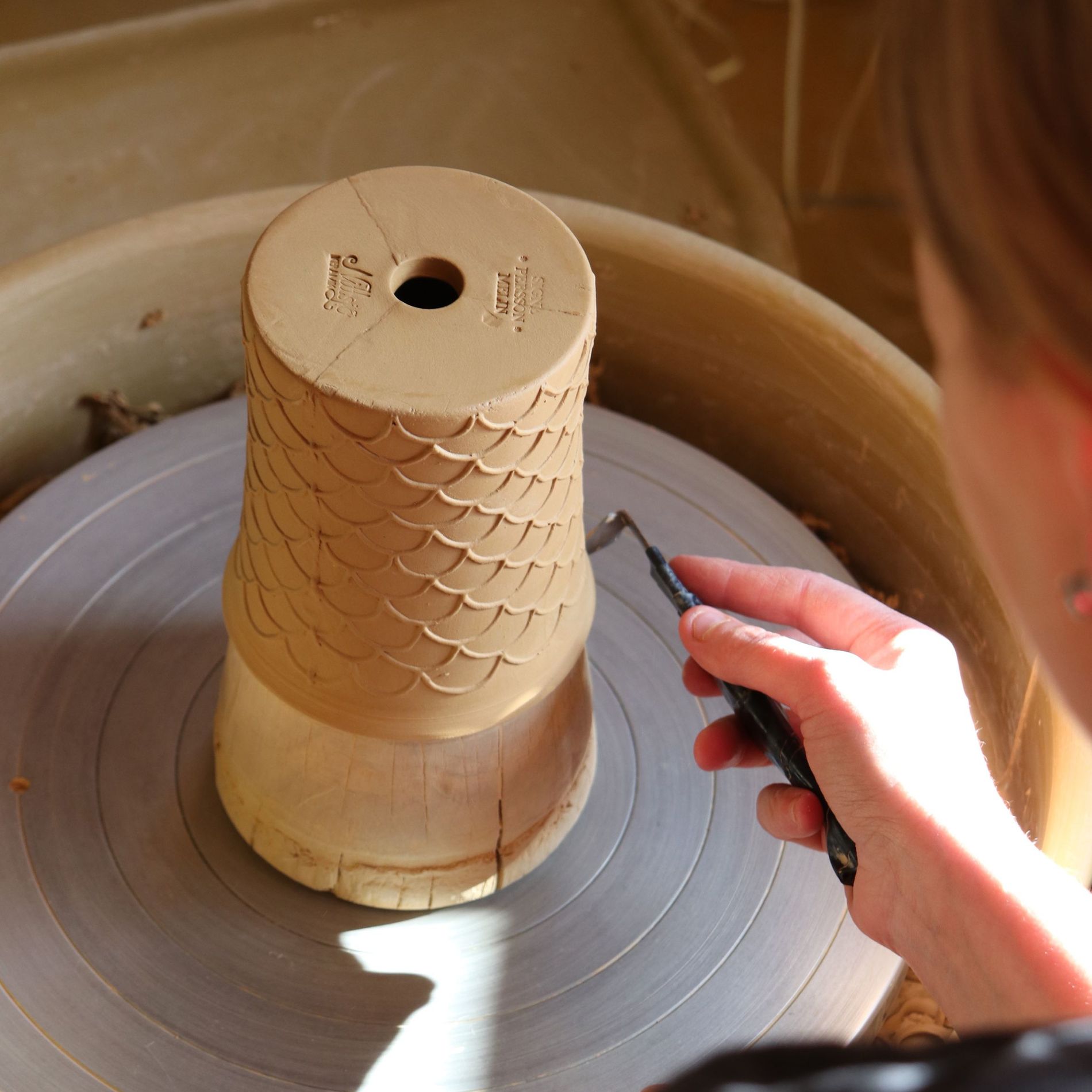 A woman crafting a vase at the Nittsjö Keramik factory
