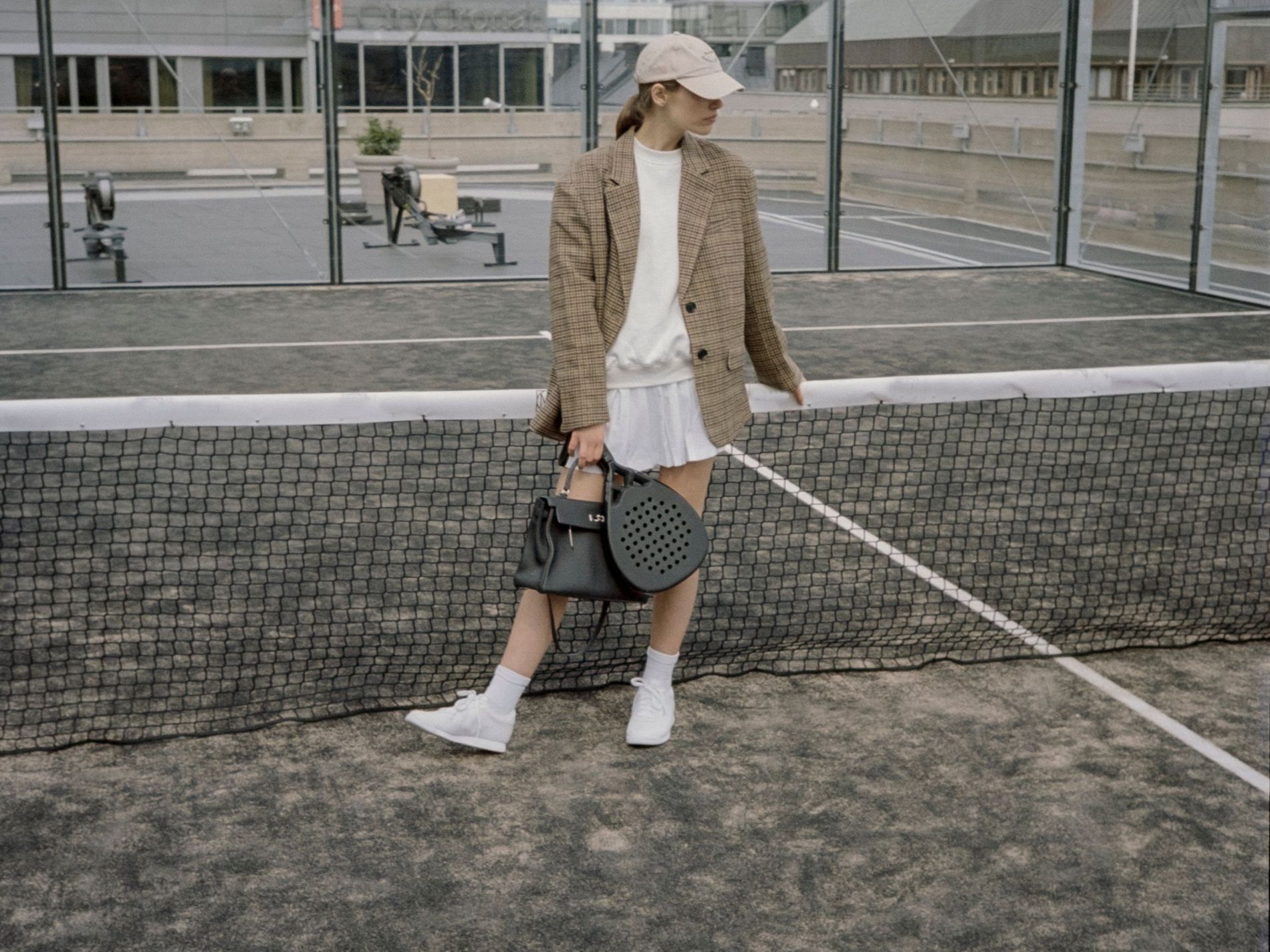 Model on padel court Ascaro with Birkin bag