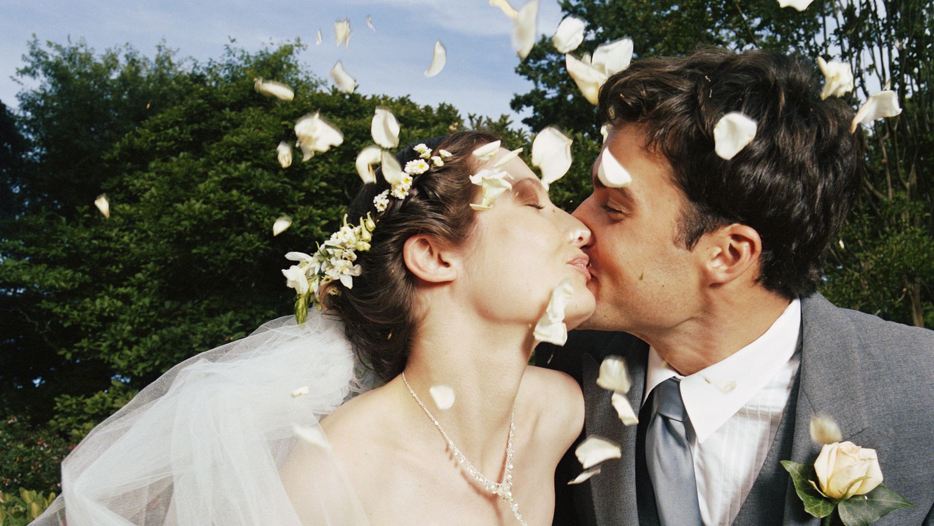 Bride and Groom in cloud of flower petals