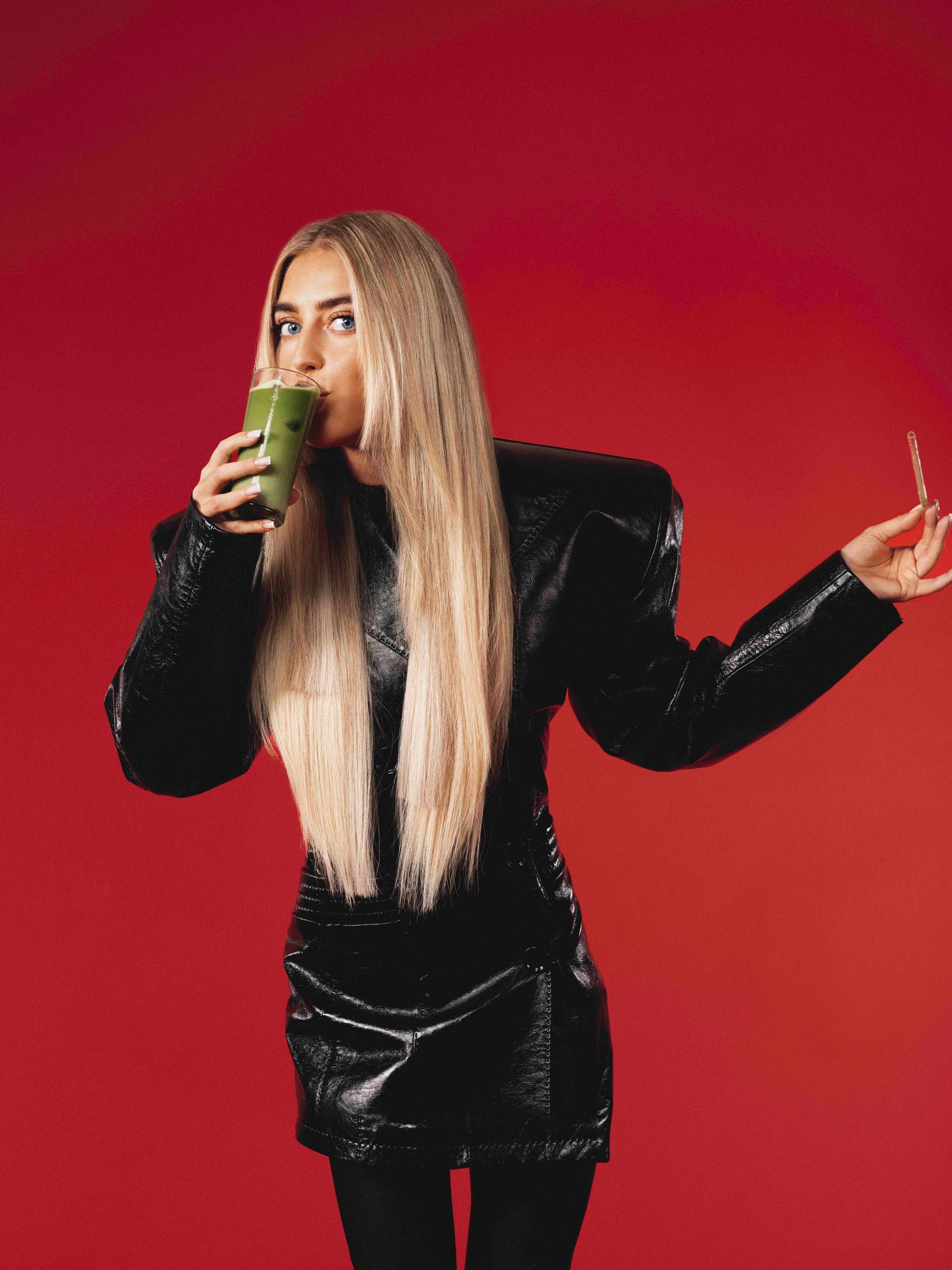 Emili Sindlev drinking a glass of matcha