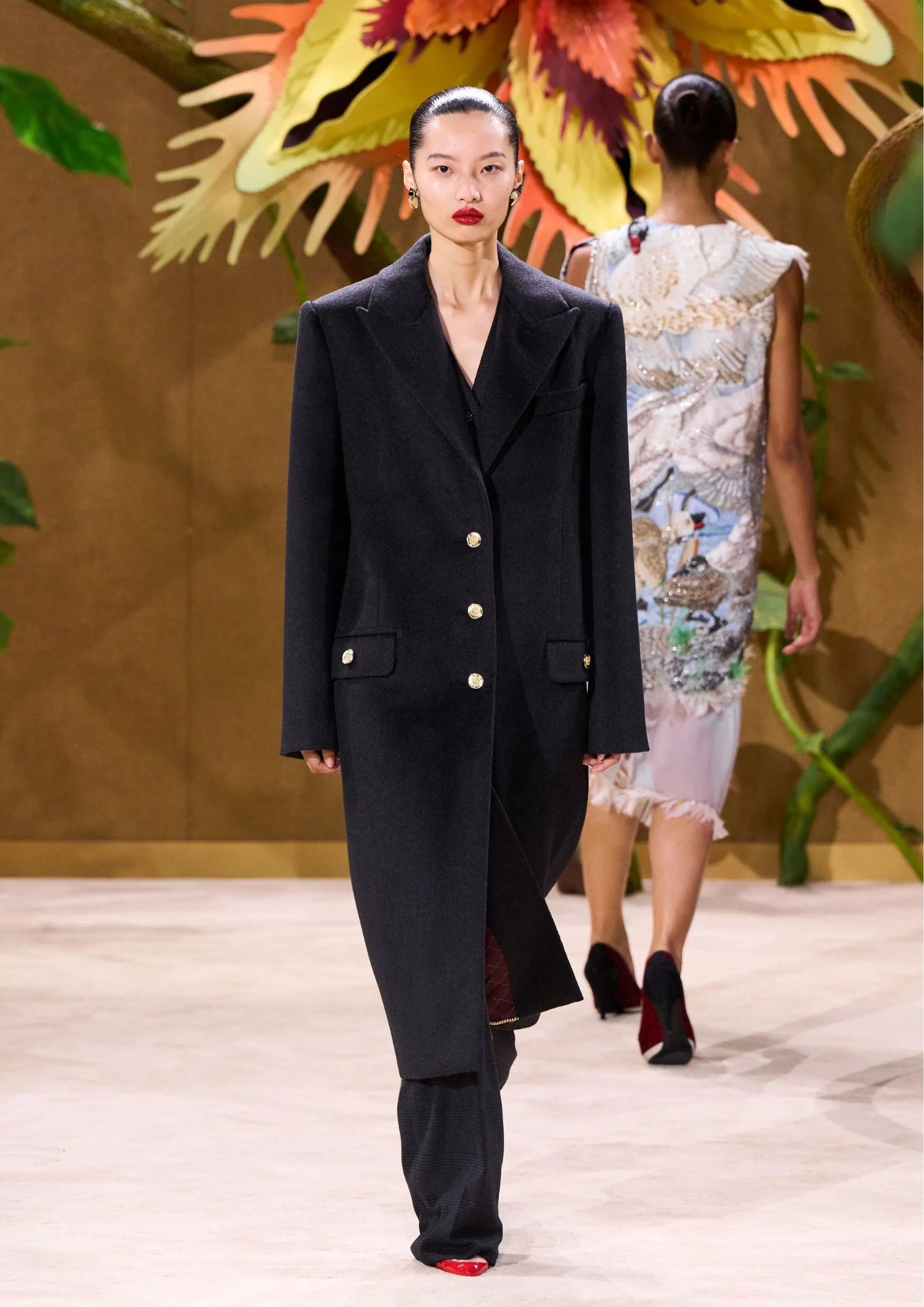 Black long coat with black trouser and red shoes