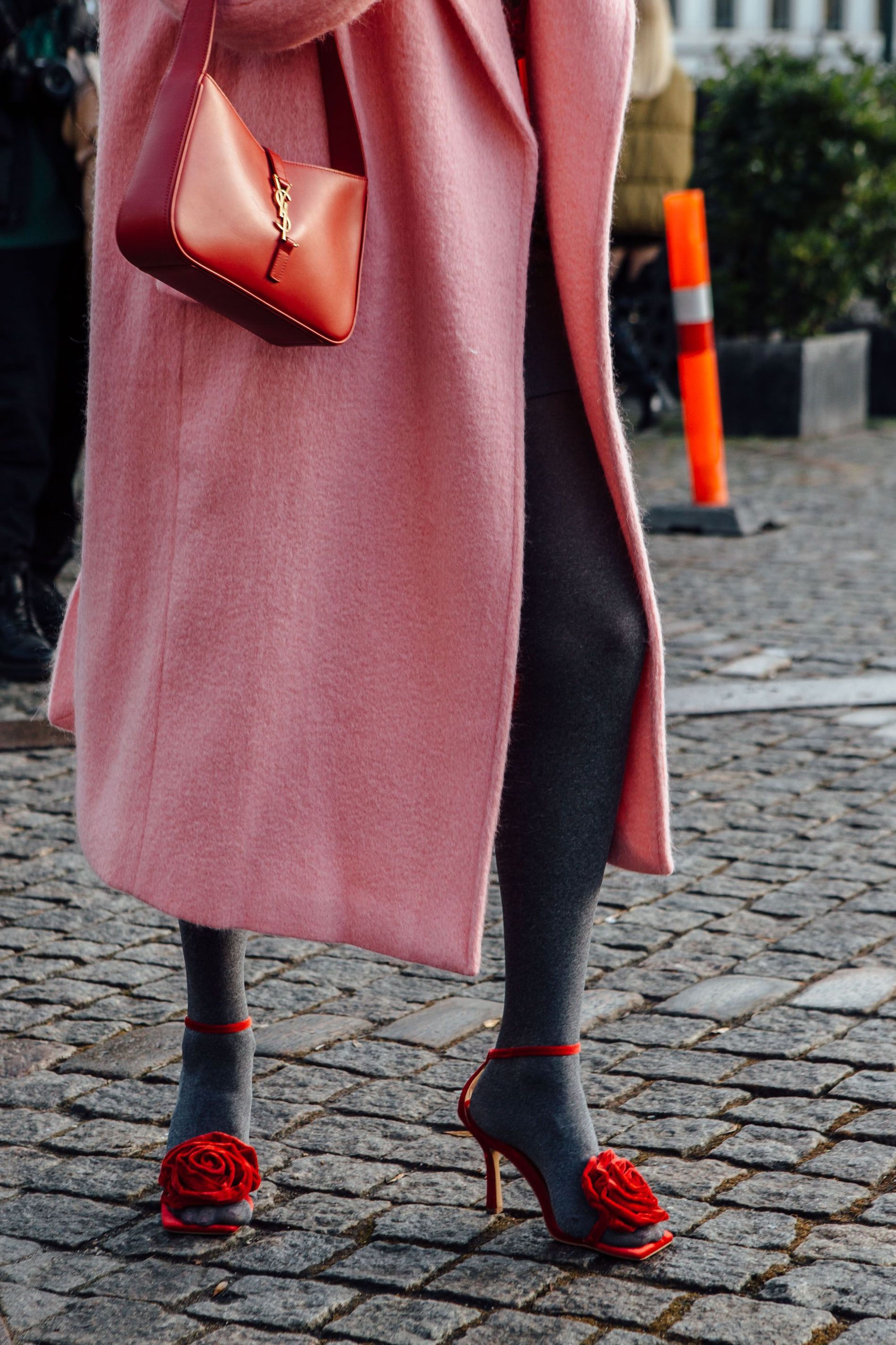 A guest wears heels with rose embellishment to Copenhagen Fashion Week AW23 