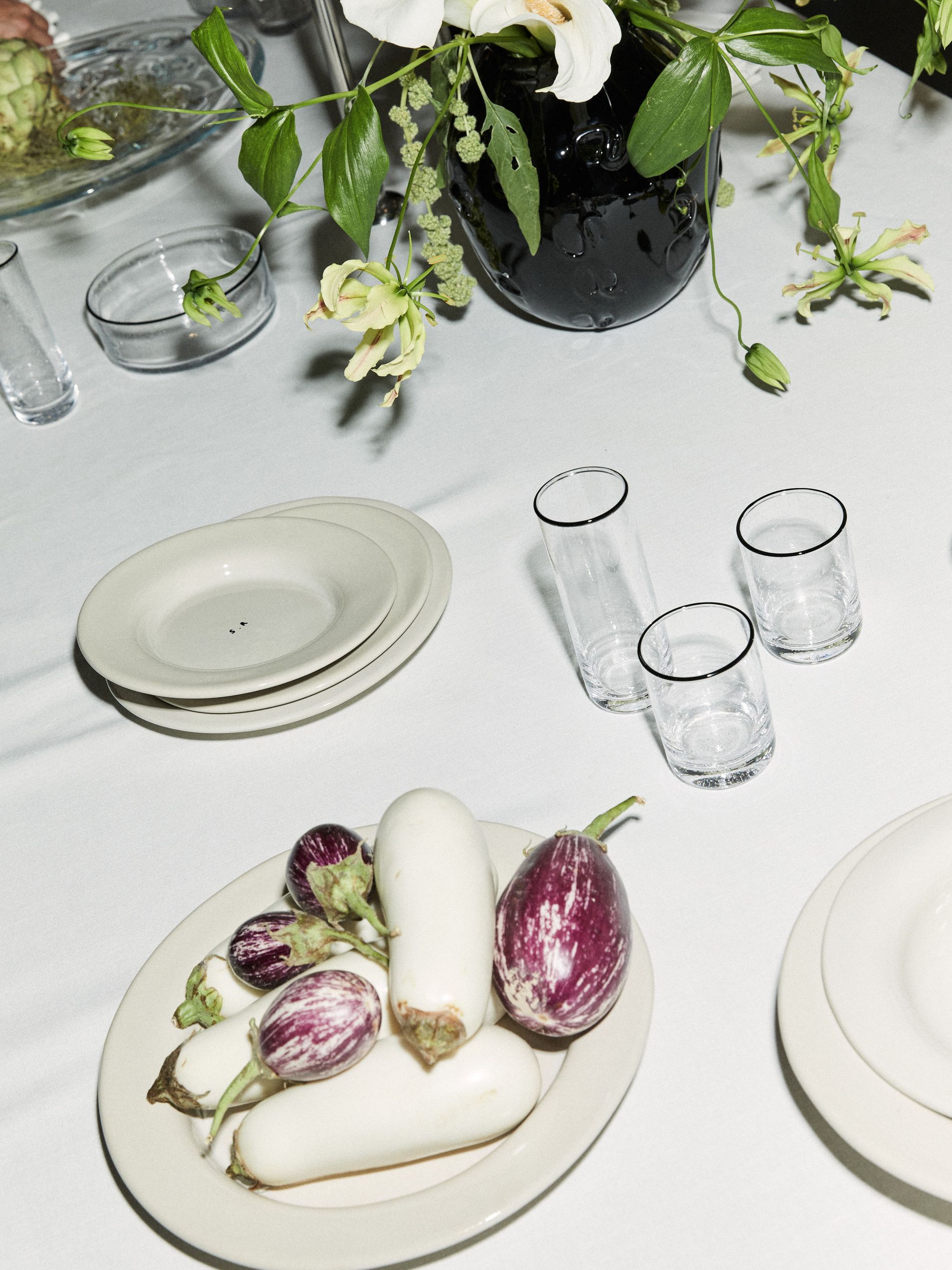 Table scape of Sophia Roe's interior collaboration, highlighting plates and glassware