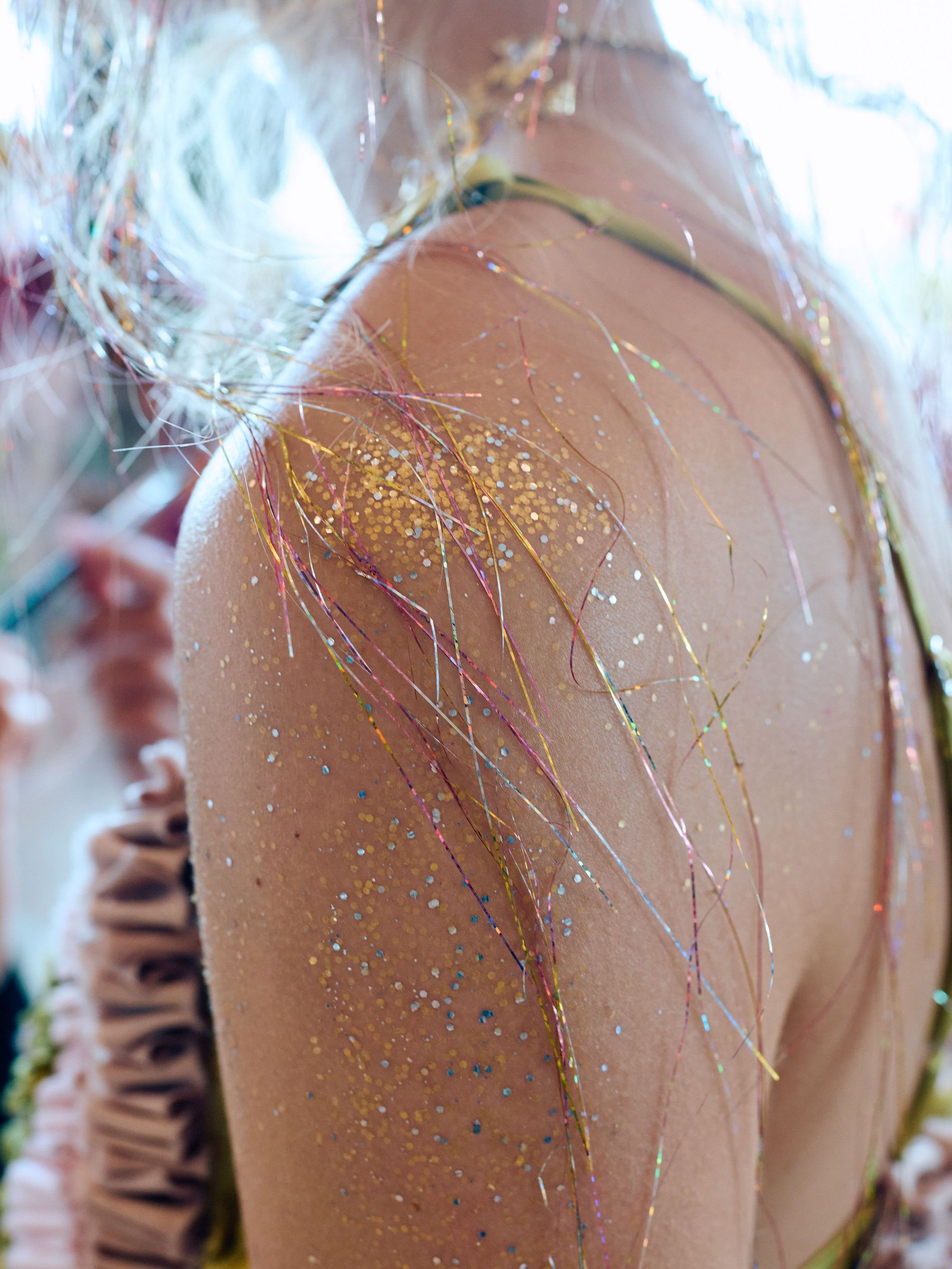 A model's glitter-encrusted shoulder at the SS27 Collina Strada show