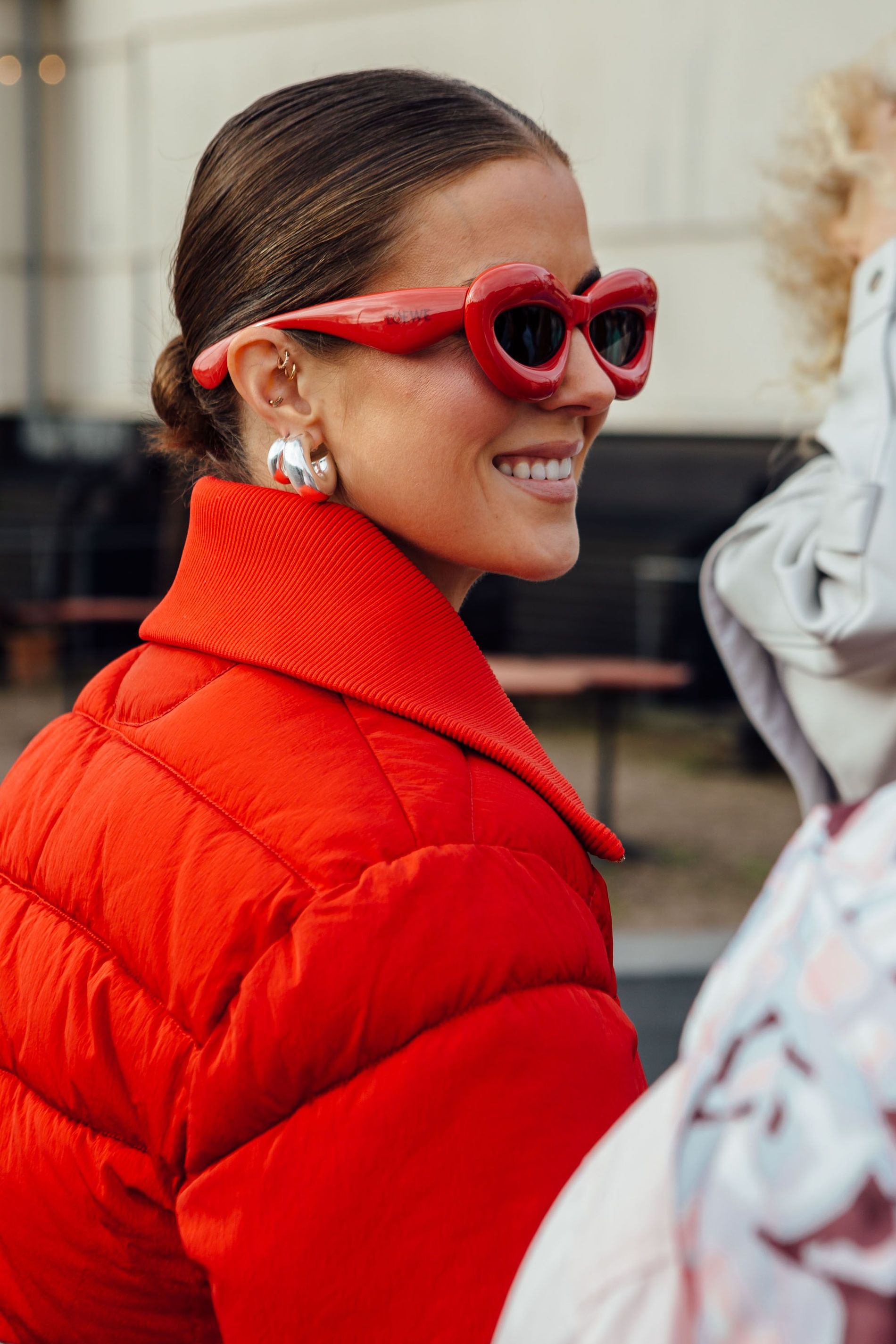 Nina Sandbech wears red bubble Loewe sunglasses with silver jewellery and a matching red puffer to Copenhagen Fashion Week AW23