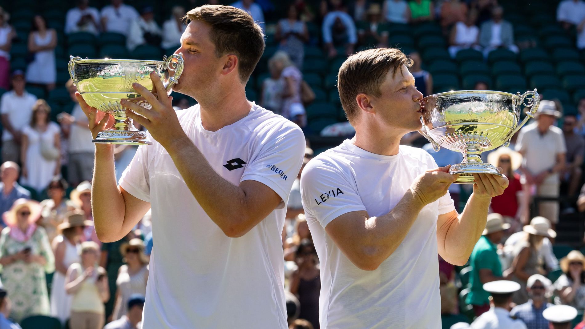 Harri Heliovaara of Finland and Henry Patten of United Kingdom pose with their Gentlemen's Doubles final trophy after their victory at Wimbledon 2026
