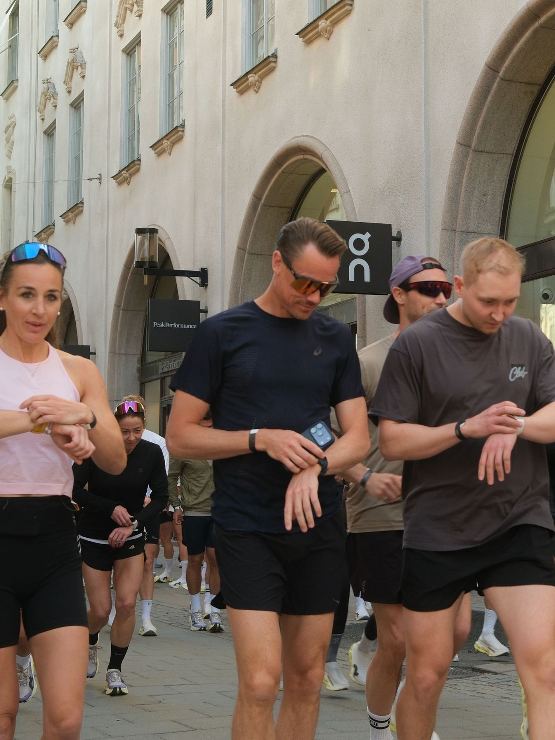 Influencers and press partaking in a 5km run set their fitness watches outside On's Stockholm store