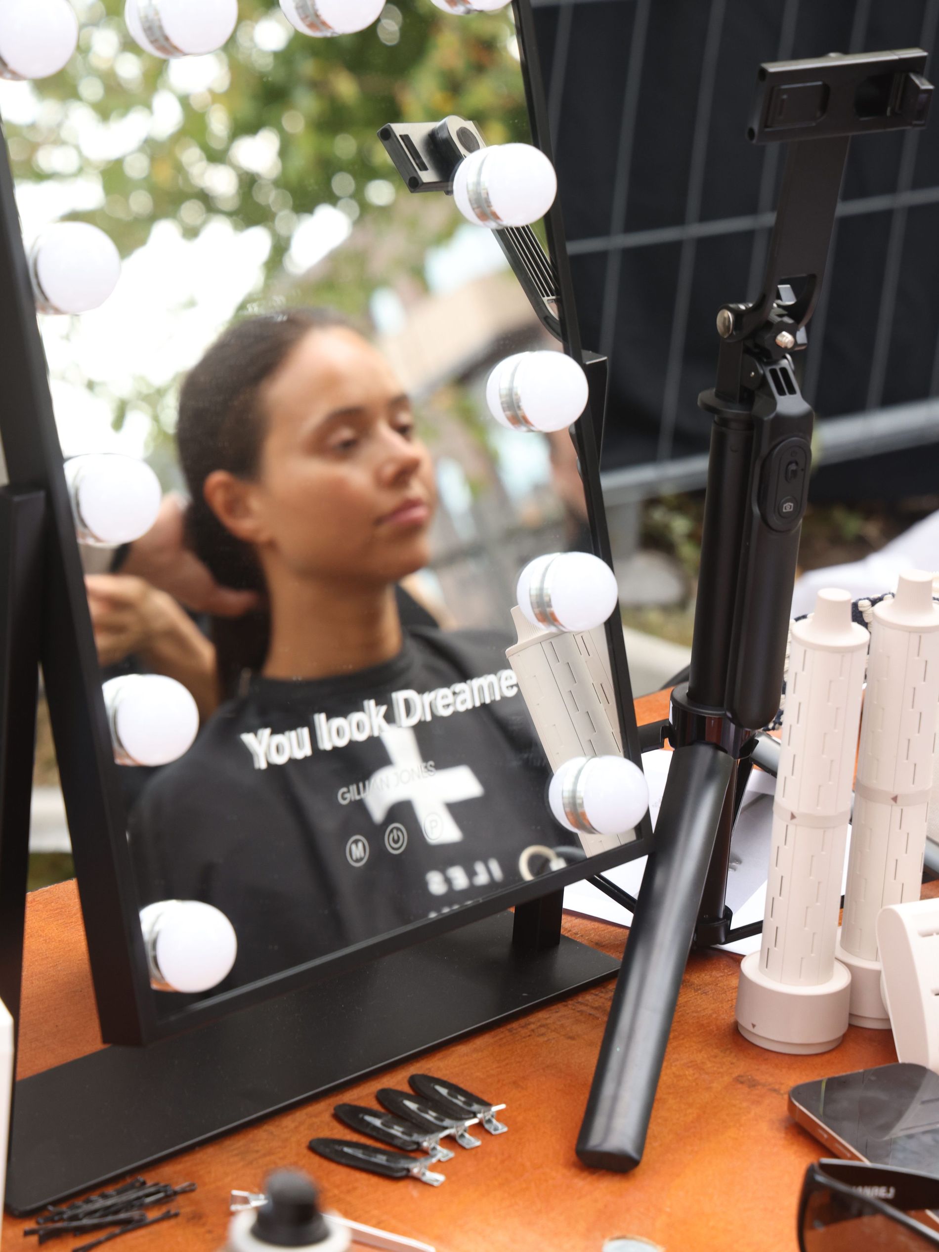 Model getting her hair done at OperaSport backstage