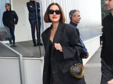 Milan Fashion Week guest wears pinstripe blazer with matching dress and sheer stockings
